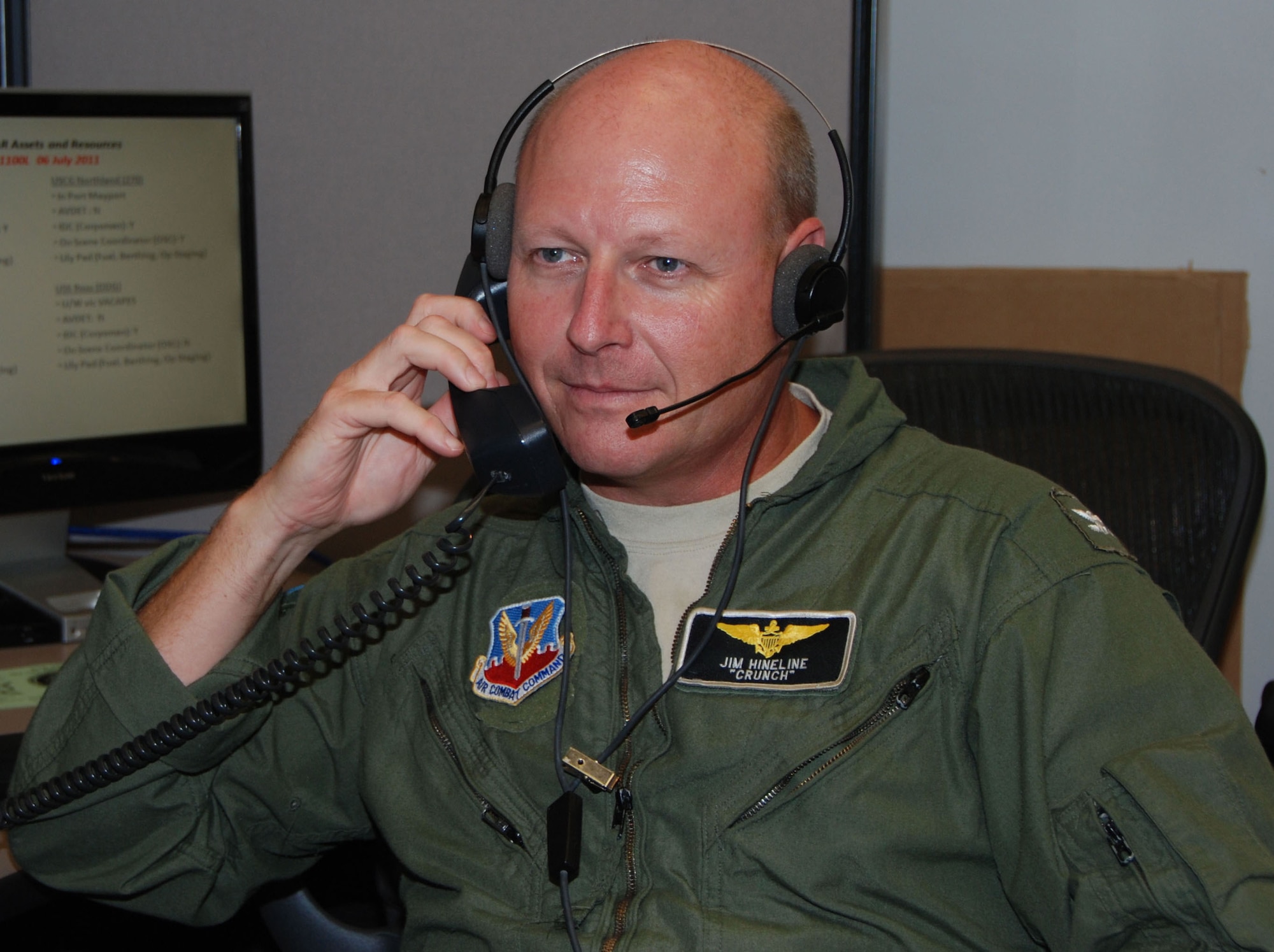 Navy Capt. James Hineline, the Joint Task Force–Space Transportation System commander, listens to transmissions at the Morrell Operations Center at Cape Canaveral Air Force Station, Fla., July 6, 2011, as the JTF-STS team prepares for the final launch of the space shuttle July 8.  (U.S. Air Force photo/Capt. Jared Scott)