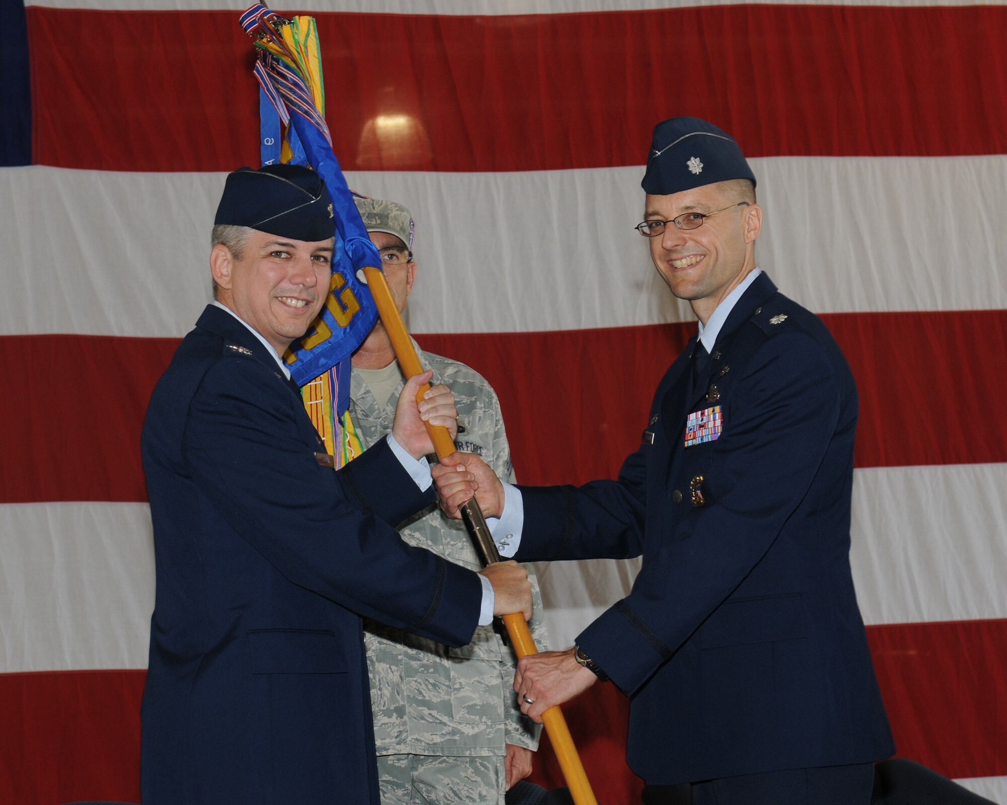 Col. Barre Seguin, 14th Flying Training Wing Commander passes the 14th Mission Support Group guidon to Colonel-select Scott Frickenstein, 14th MSG Commander during a change of command ceremony on July 6. Frickenstein previously led the Analysis Branch in the Force Support Division, Directorate of Force Structure, Resources and Assessment, Joint Staff, the Pentagon, Washington, D.C. (U.S. Air Force photo/Melissa Doublin)