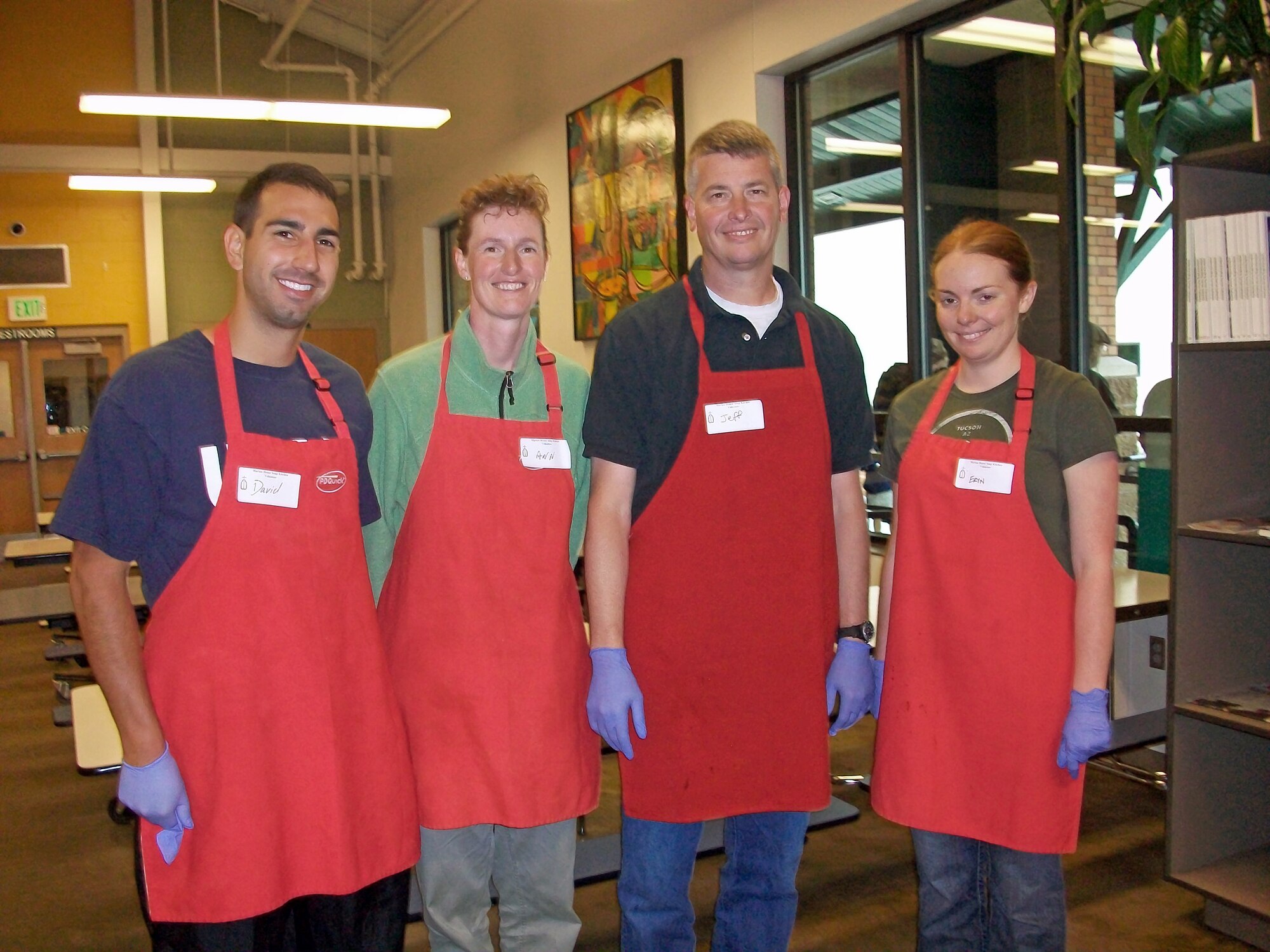 COLORADO SPRINGS, Colo. –From left to right, 1st Lt. David Rothzeid, Rocky Mountain Company Grade Officer Council; Lt. Col. Ann Igl, 21st Force Support Squadron commander; Col. Jeffrey Flewelling, 21st Space Wing vice commander; and 1st Lt. Eryn Meeks, Rocky Mountain CGOC, stop to take a photo while volunteering at the Marian House Soup Kitchen in Colorado Springs June 19, 2011. Members of the Rocky Mountain CGOC, as well as many Airmen from Peterson Air Force Base, volunteer at the soup kitchen once a month to help families in need. For more information on the CGOC contact 2nd Lt. Emily Donaldson at 566-0128. For information on volunteer opportunities in the Colorado Springs area visit: www.volunteerpikespeak.org. (Courtesy photo)