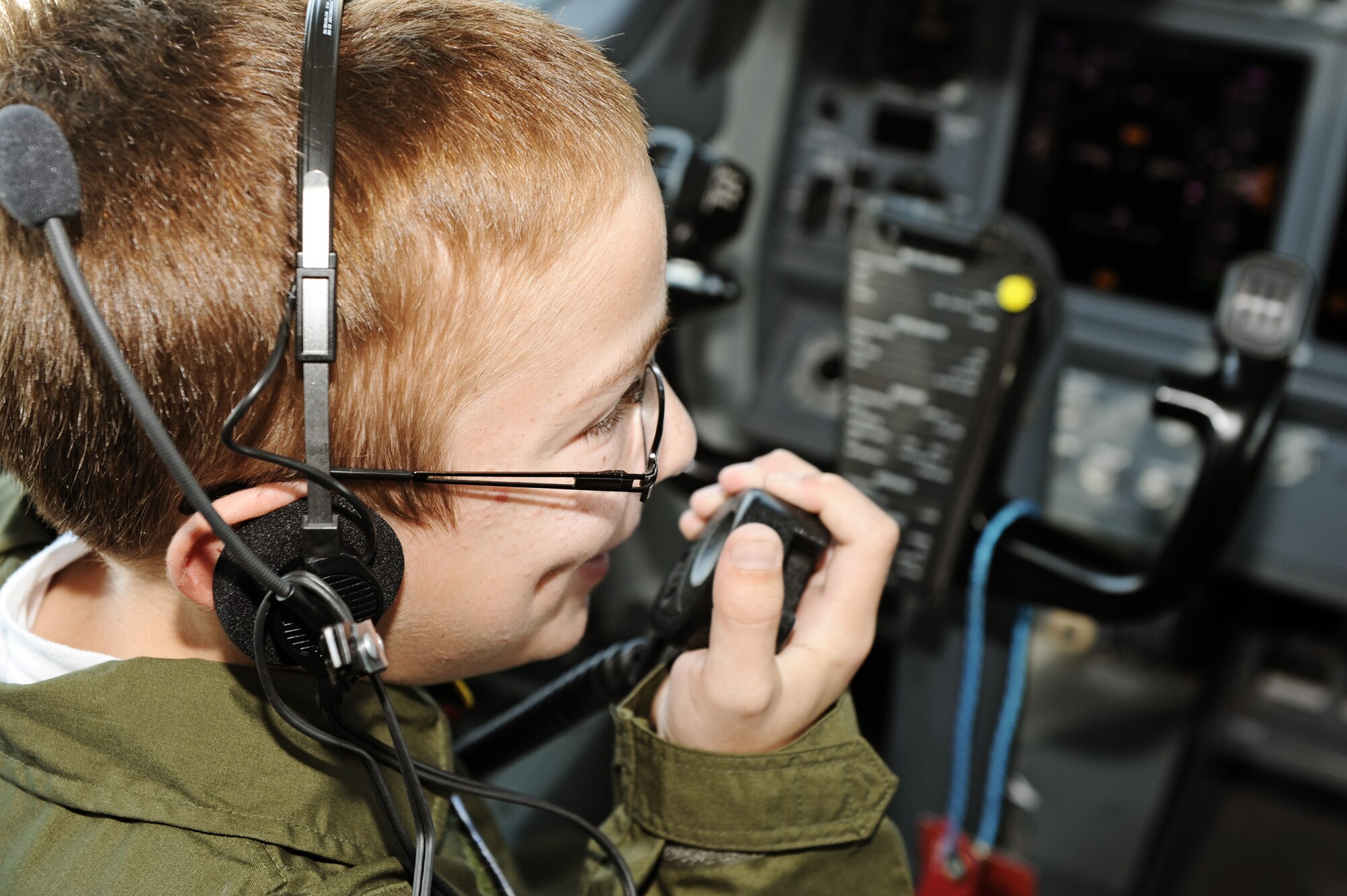 Jared Anderson communicates with the control tower from a radio aboard a C-40C during his visit for the Pilot for a Day program July 7, 2011 at Scott Air Force Base, Ill. Jared, who is diagnosed with chronic kidney disease, was nominated to come to Scott and be a pilot for a day. The program gives seriously ill children a close up look at the Air Force. His day consisted of multiple events and tours to include a C-21A taxi ride, a military working dog demonstration, tower tour, and a ride in a flight simulator. (U.S. Air Force photo/Staff Sgt. Brian J. Valencia)