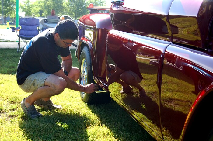 Duane Blue is reflected in the side panel of his 1961 Chevy Apache pickup as he polishes the tailpipe at the 309th Maintenance Wing Car Show June 30. The truck won first in its category. (U.S. Air Force photo by Bill Orndorff)