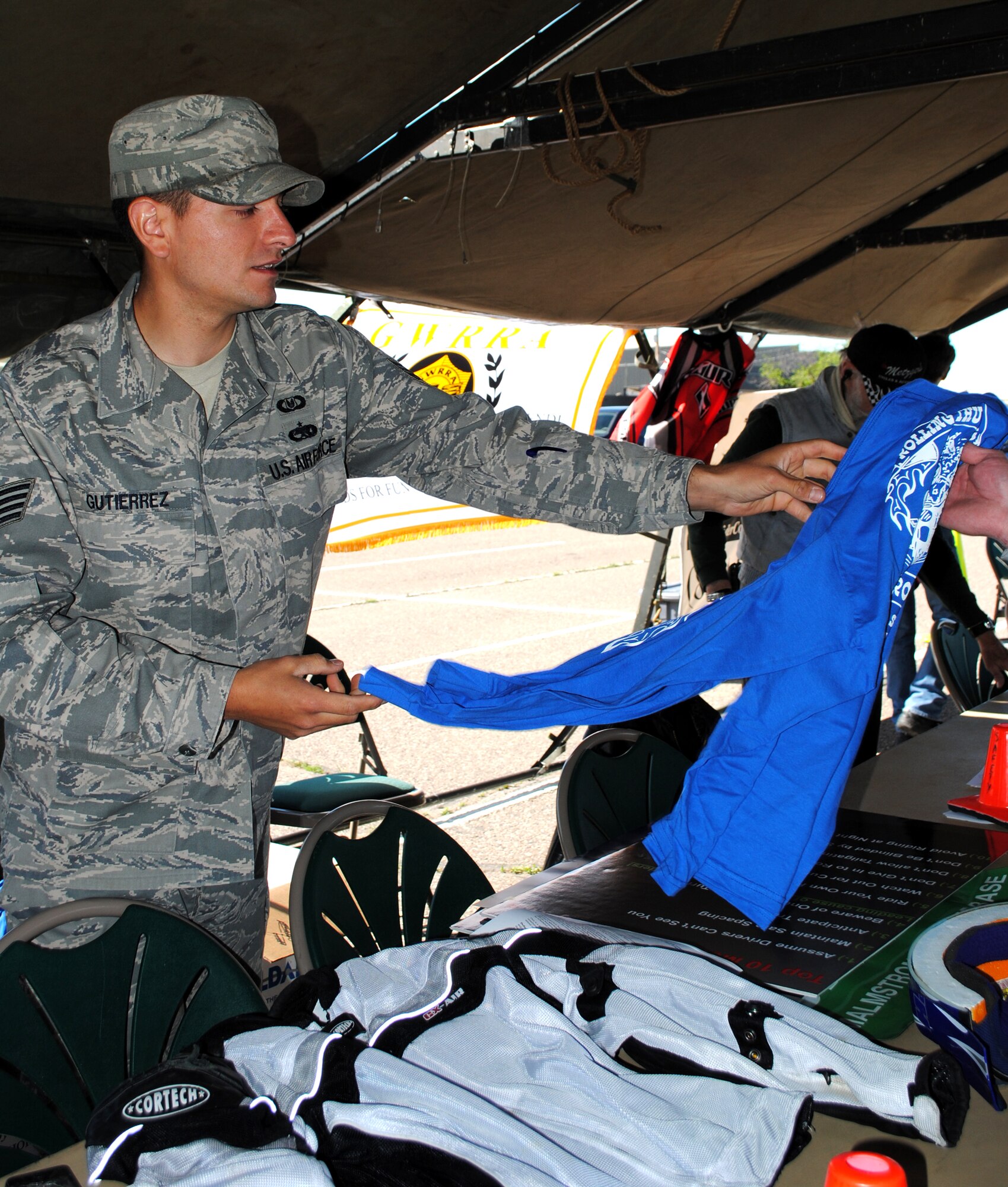 Staff Sgt. Victorio Gutierrez, 341st Missile Wing safety, hands out free T-shirts promoting Rolling Thunder June 30.  The motorcycle safety awareness event drew more than 250 individuals.  (U.S. Air Force photo/Airman 1st Class Katrina Heikkinen)