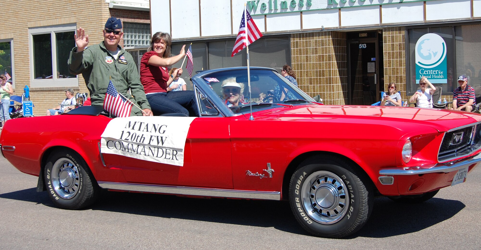 Col. Pete Hronek, 120th Fighter Wing commander, and his wife, Traci, wave to parade-goers as they pass by. (U.S. Air Force photo/Valerie Mullett)