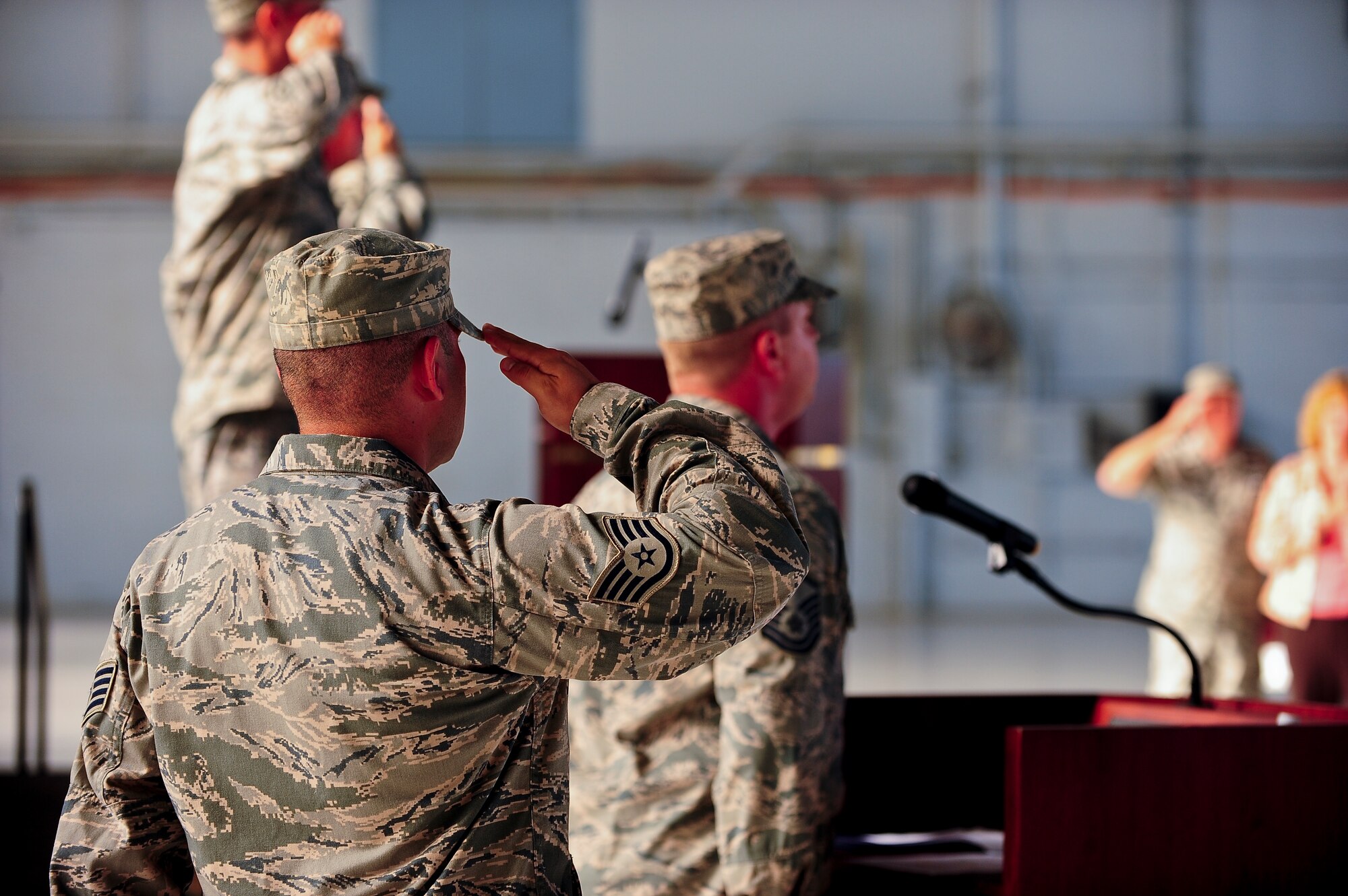 U.S. Airmen render a salute as Master Sgt. Harry Bound sings the National Anthem during the 6th Mission Support Group Change of Command ceremony at MacDill Air Force Base, Fla., July 6, 2011. Col. Donald Barnes relinquishes his command to Col. James Hodges. (US Air Force photo by Airman 1st Class Melanie Bulow-Gonterman/Released)
