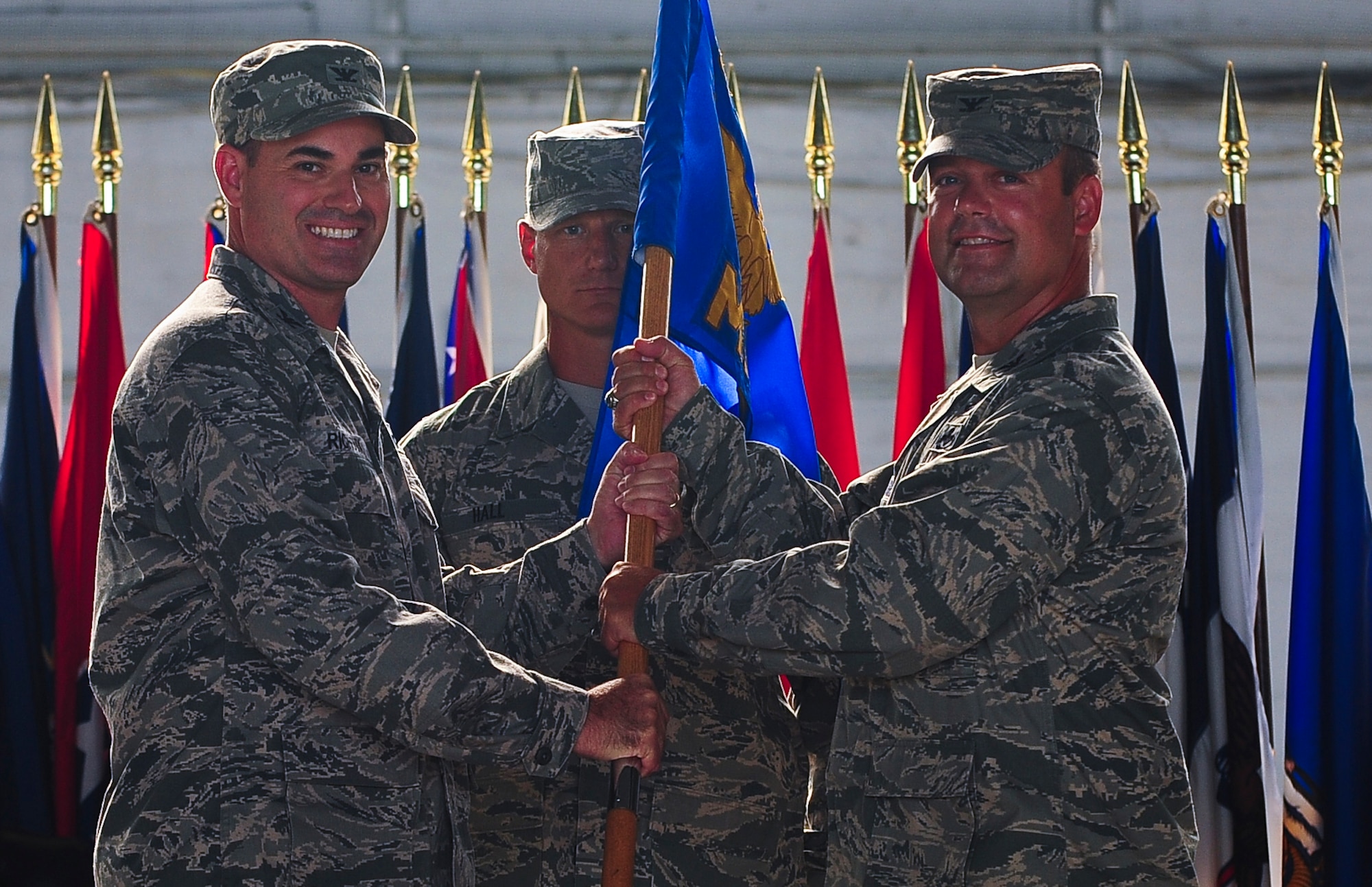 Col. Lenny Richoux, 6th Air Mobility Wing commander, passes the guideon to Col. James Hodges, 6th Mission Support Group commander, during the Change of Command ceremony at MacDill Air Force Base, Fla., July 6, 2011. (US Air Force photo by Airman 1st Class Melanie Bulow-Gonterman/Released)