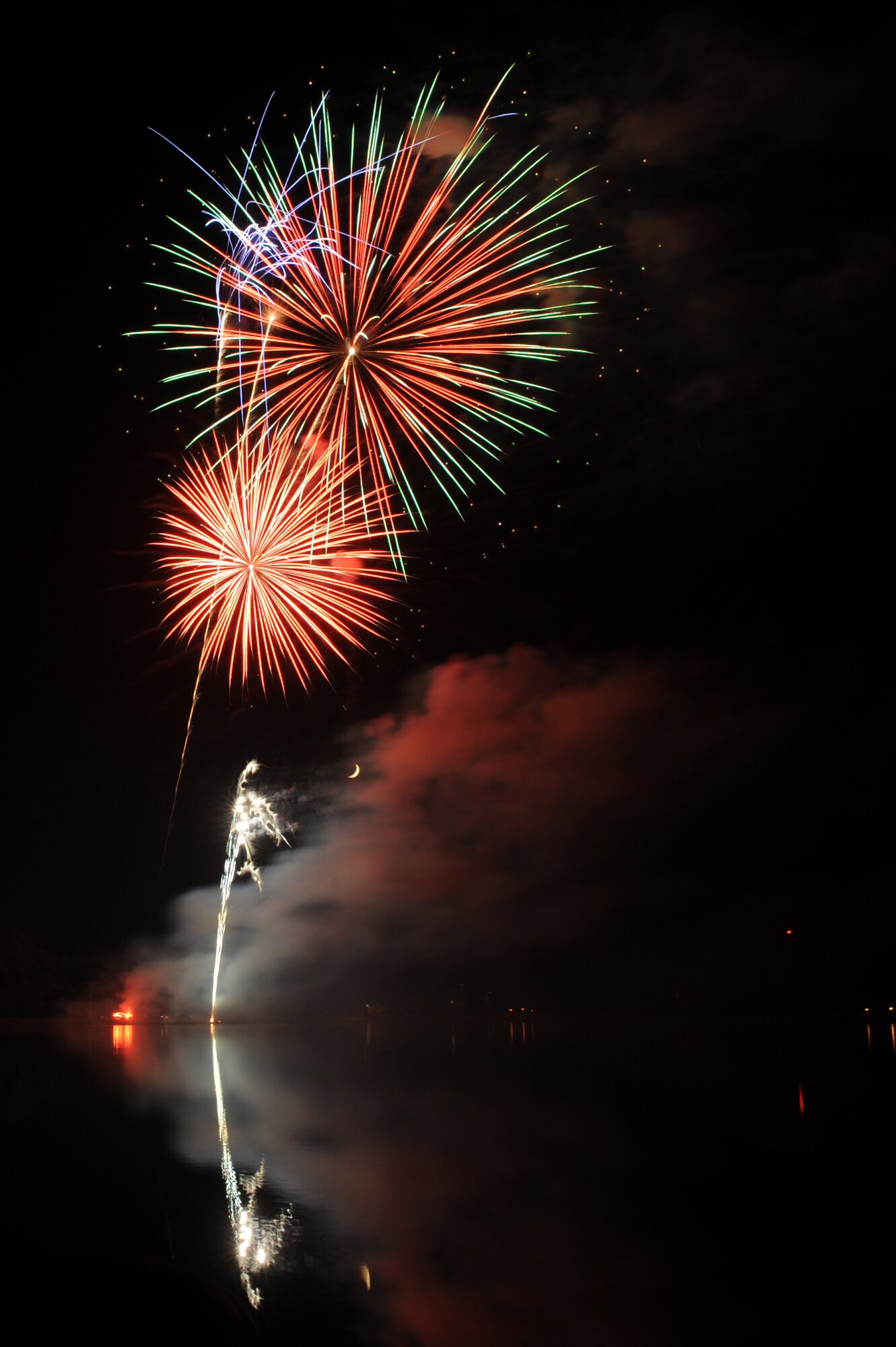 Fireworks light up the evening sky with a shower of vibrant colors during the Little Rock Air Force Base Fourth of July celebration at Little Rock Air Force Base, Ark.  The fireworks display capped off an afternoon of activities including the Air Mobility Command Icon contest, games and a family parade. (U.S. Air Force photo by Tech. Sgt. Chad Chisholm)