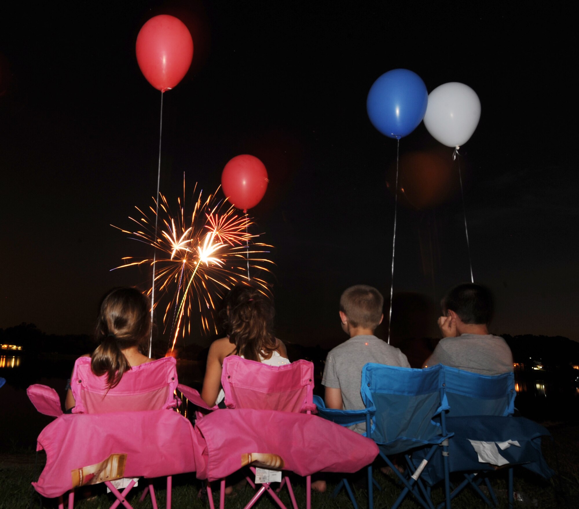 (Left to right) Chloe Saunders, Haley Saunders, Zackry Saunders and Blane Saunders, children of Senior Airman Christopher Saunders, a 19th Logistics Readiness Squadron fuel distribution operator, watch fireworks explode on July 4, 2011 at Little Rock Air Force Base, Ark.  The fireworks display capped off an afternoon of activities including the Air Mobility Command Icon contest, games and a family parade. (U.S. Air Force photo by Tech. Sgt. Chad Chisholm)