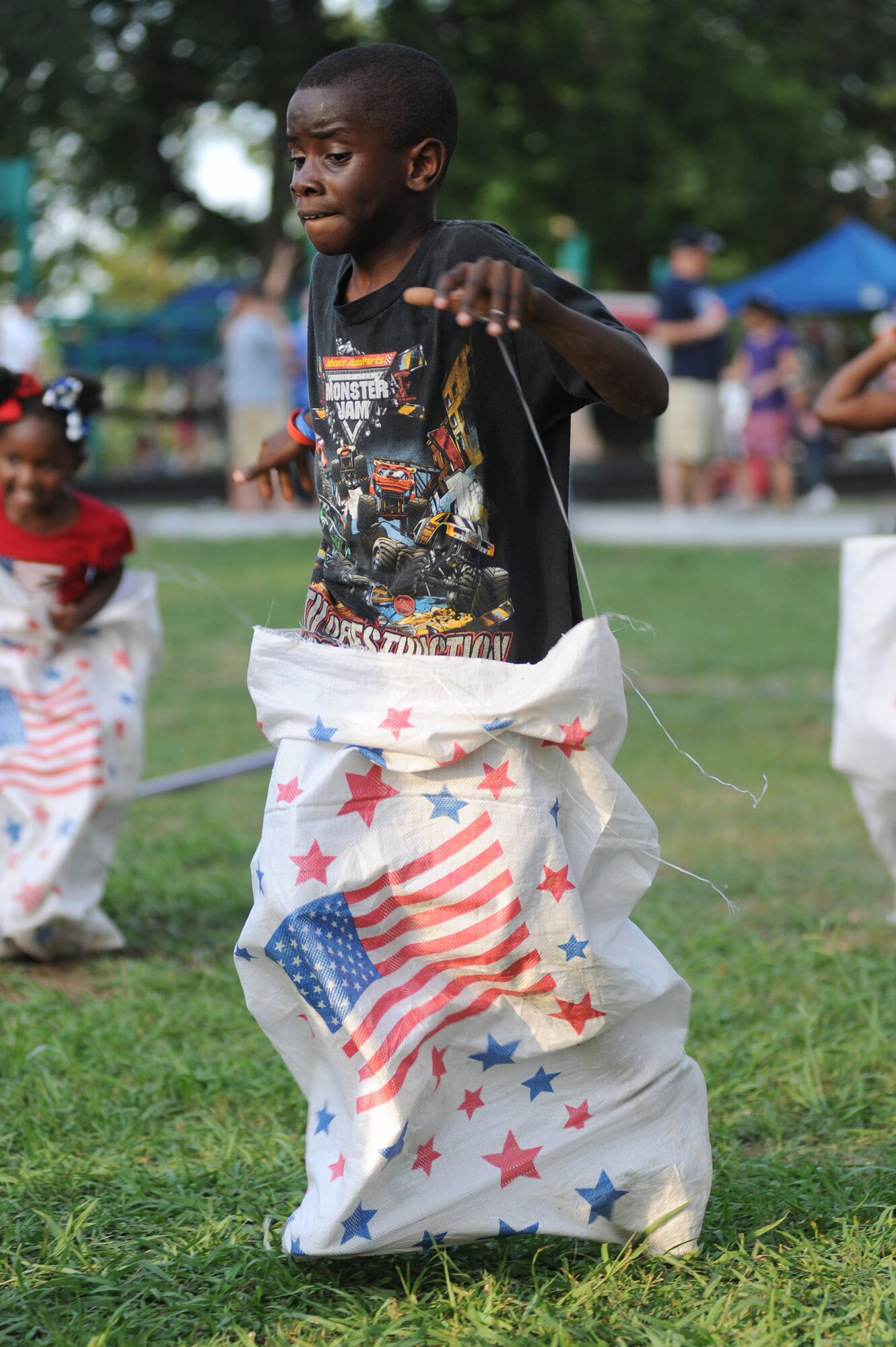 Josh Gardner, son of Paul Gardner, participates in a sack race during the Fourth of July celebration at Little Rock Air Force Base, Ark.  The Little Rock AFB Fourth of July celebration highlighted the Air Mobility Command Icon contest, games and a family parade and ended with a fireworks display. (U.S. Air Force photo by Tech. Sgt. Chad Chisholm)