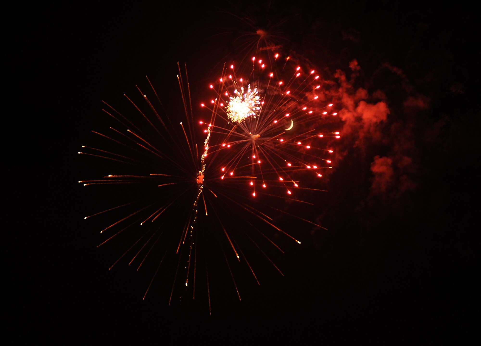 Families gather around the base lake to watch a fireworks show on July 4, 2011, at Little Rock Air Force Base, Ark. The fireworks display capped off an afternoon of activities including the Air Mobility Command Icon contest, games and a family parade.   (U.S. Air Force photo by Airman 1st Class Ellora Remington)