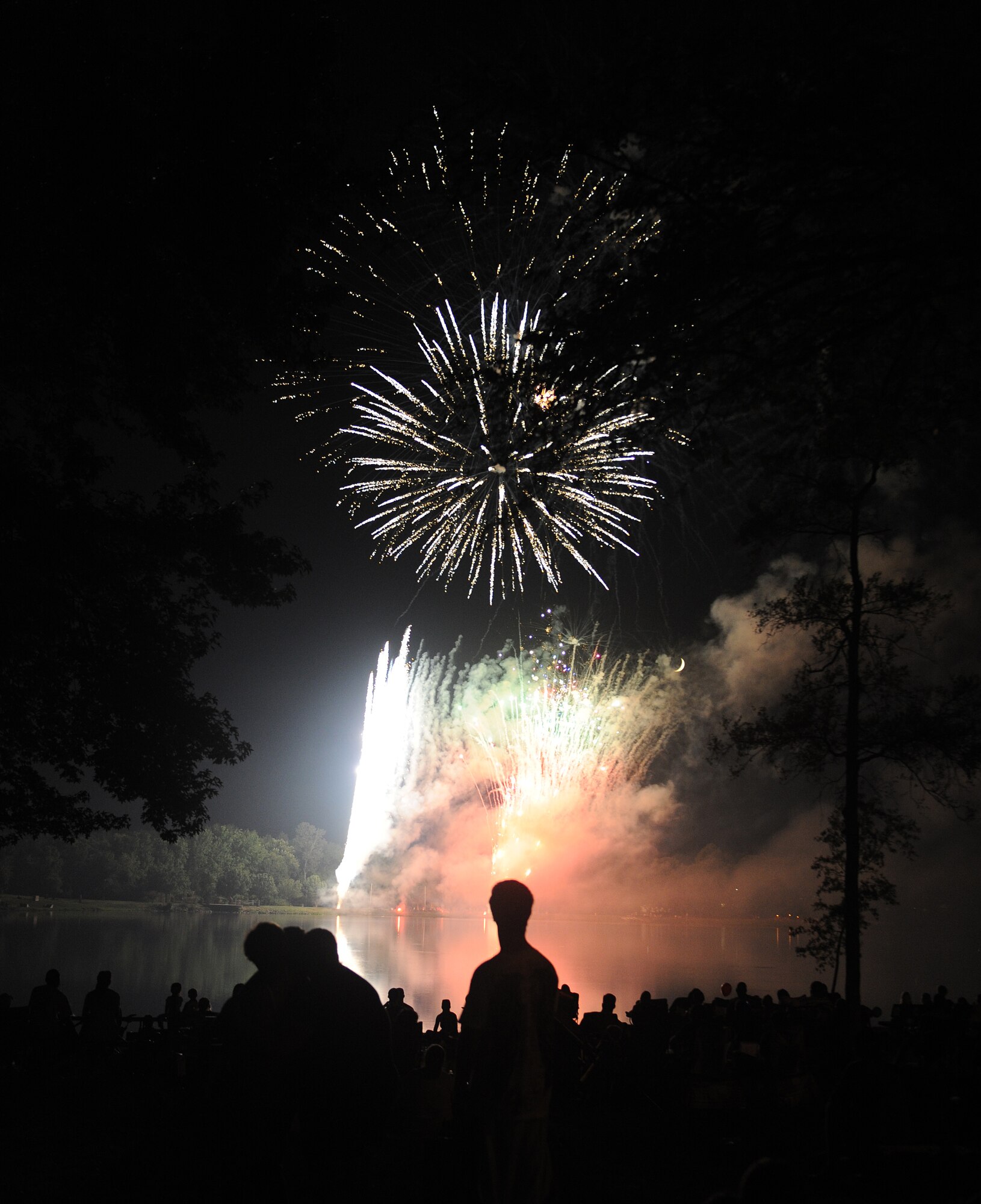 Families gather around the base lake to watch a fireworks show on July 4, 2011, at Little Rock Air Force Base, Ark. The fireworks display capped off an afternoon of activities including the Air Mobility Command Icon contest, games and a family parade.   (U.S. Air Force photo / Airman 1st Class Ellora Remington)