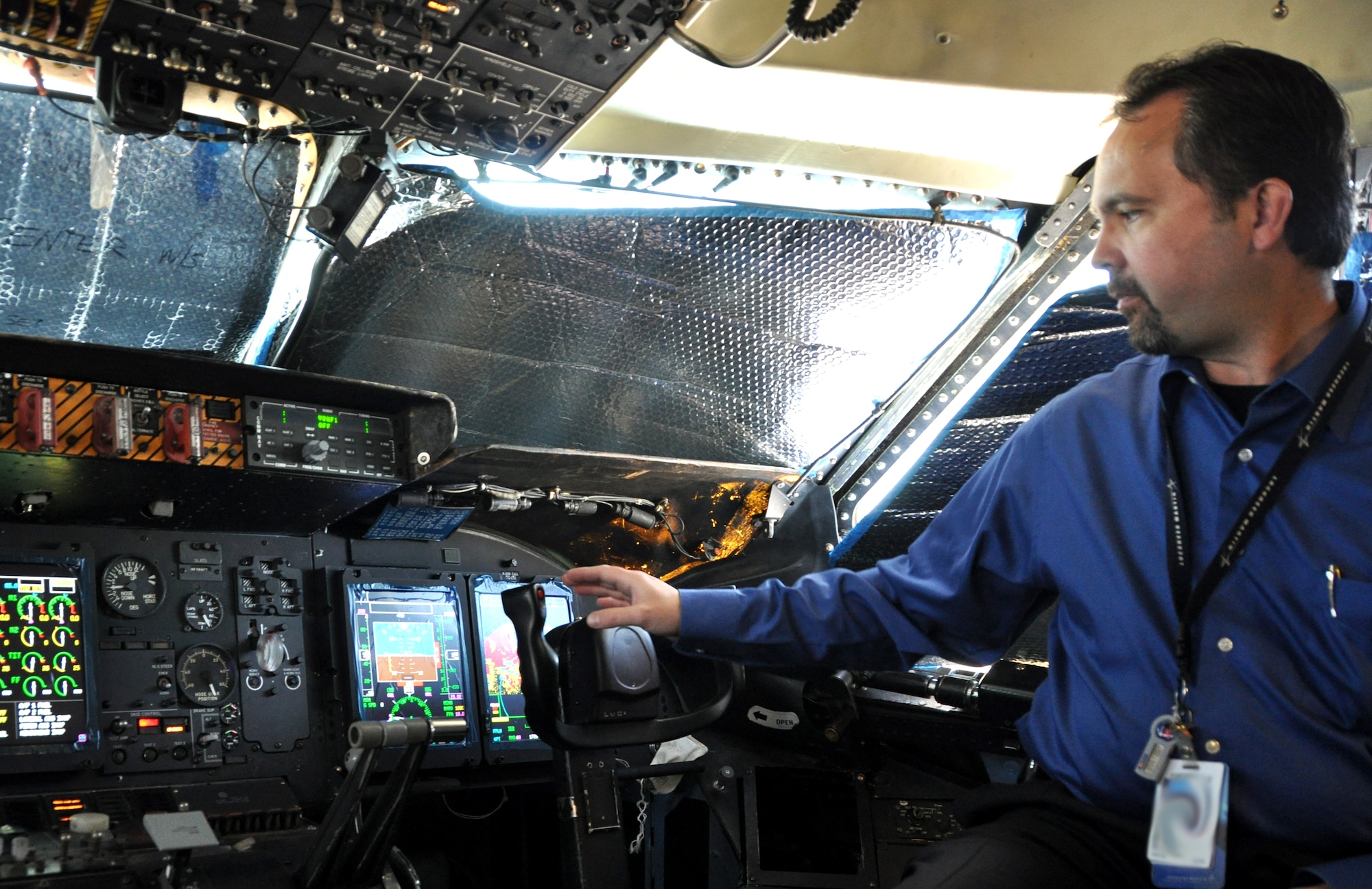 Denny Pyle, engineering technician, shows off the C-5 Galaxy’s new digital cockpit displays June 27. (U.S. Air Force photo/ Staff Sgt. Timothy Boyer)