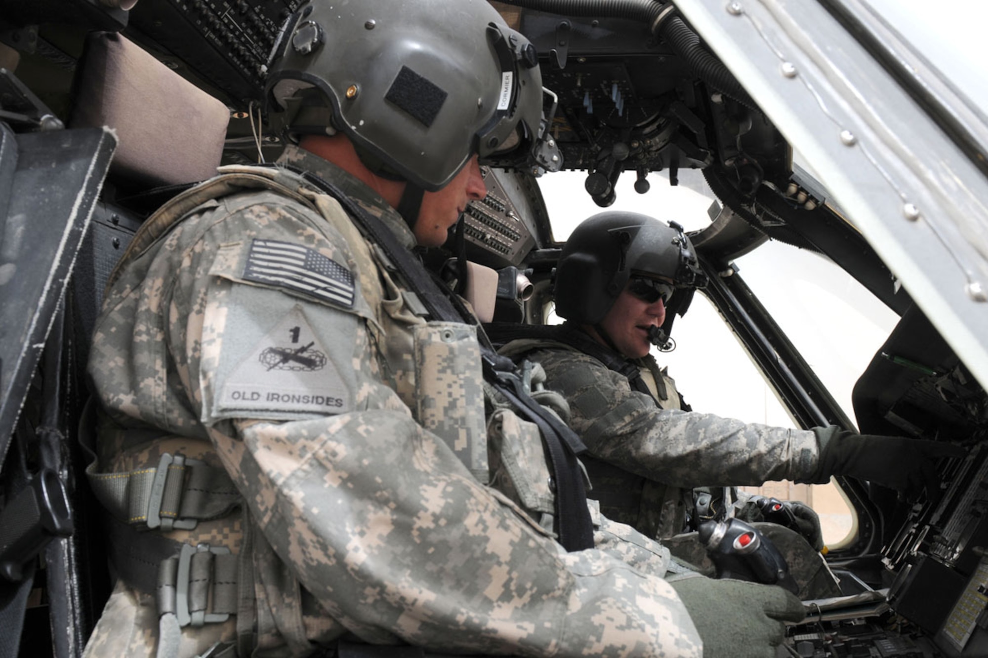 BAGHDAD, Iraq -- Chief Warrant Officer 2 Joshua Cormier (left), aviator with B Company, 1st Battalion, 207th Aviation Regiment, and Capt. Todd R. Miller, aviator and company commander of B/1-207th Avn. perform flight checks on their UH-60 Black Hawk helicopter before a mission. (U.S. Army photo/Sgt. TJ Moller)