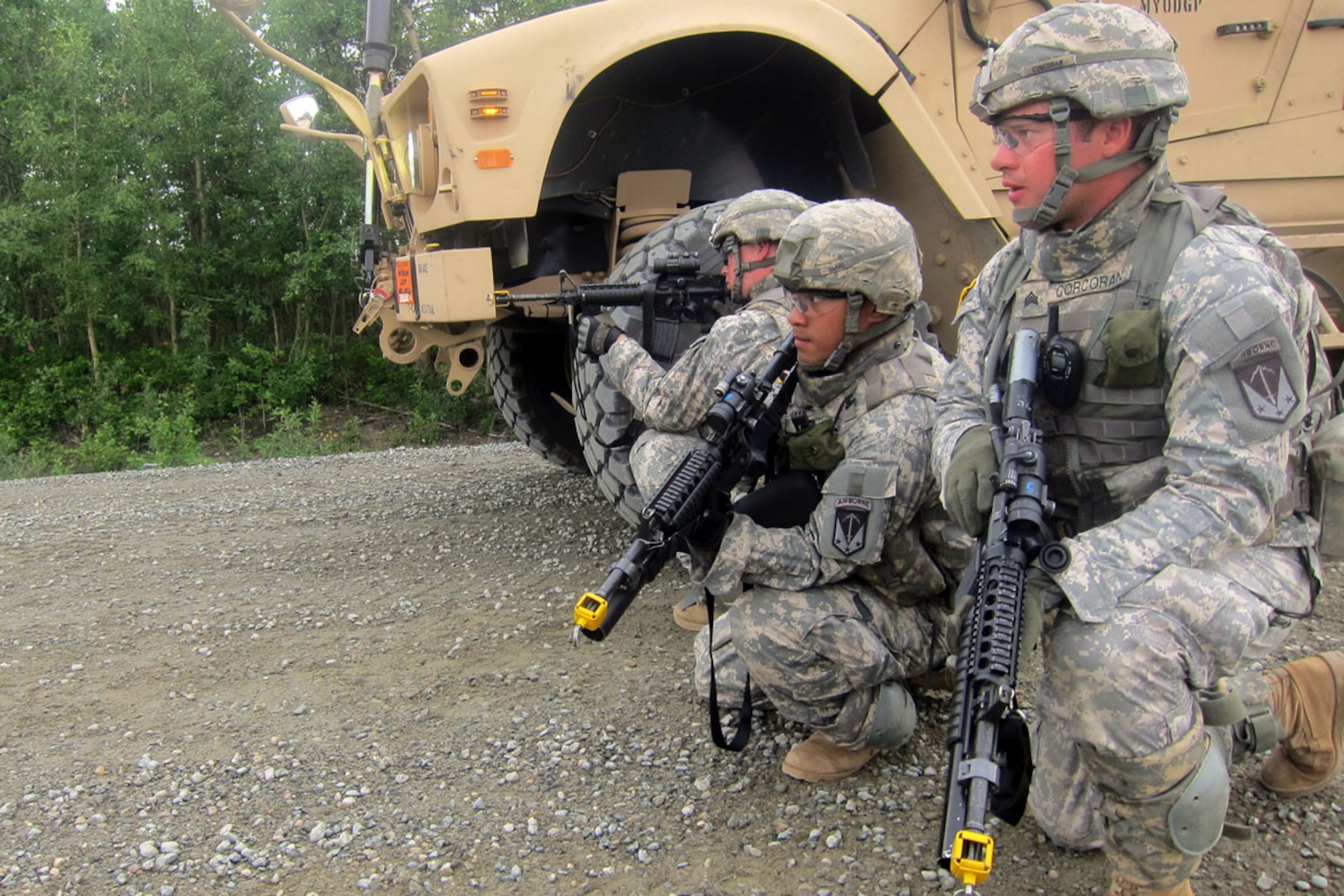 JOINT BASE ELMENDORF-RICHARDSON, Alaska -- Sgt. David Corcoran, right, and Sgt. Wesner Takeo, center, analyze the situation while Spc. William Cleveland, left, provides forward security at a hasty traffic control point during the scenario-based training lane on Donnelly Training Area, Fort Greely, during Operation Tundra Wolf.  (U.S. Army photo by Capt. Richard Packer/6th Engineer Battalion)