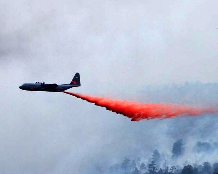 A C-130 Modular Airborne Fire Fighting System-equipped aircraft performs a fire drop onto the Las Conchas on July 2. The MAFFS is one of four assigned to the 302nd Air Expeditionary Group to fight numerous wildfires in the Southwestern United States. Courtesy Photo by Jason Coil