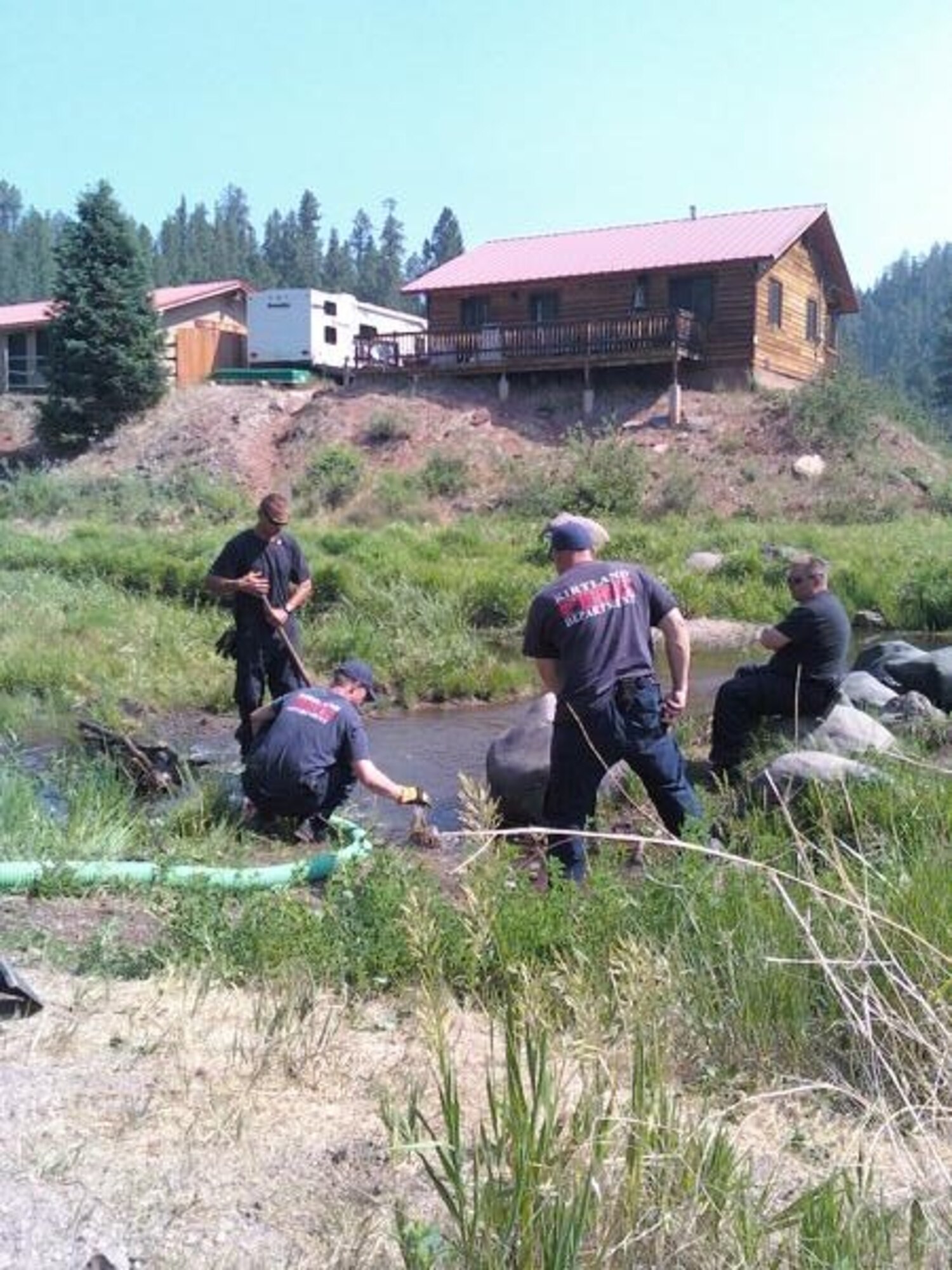 Firefighters from Kirtland Air Force Base draft water in preparation for fire containment near Los Alamos, N.M.  Courtesy Photo by Ananda Dinsmore