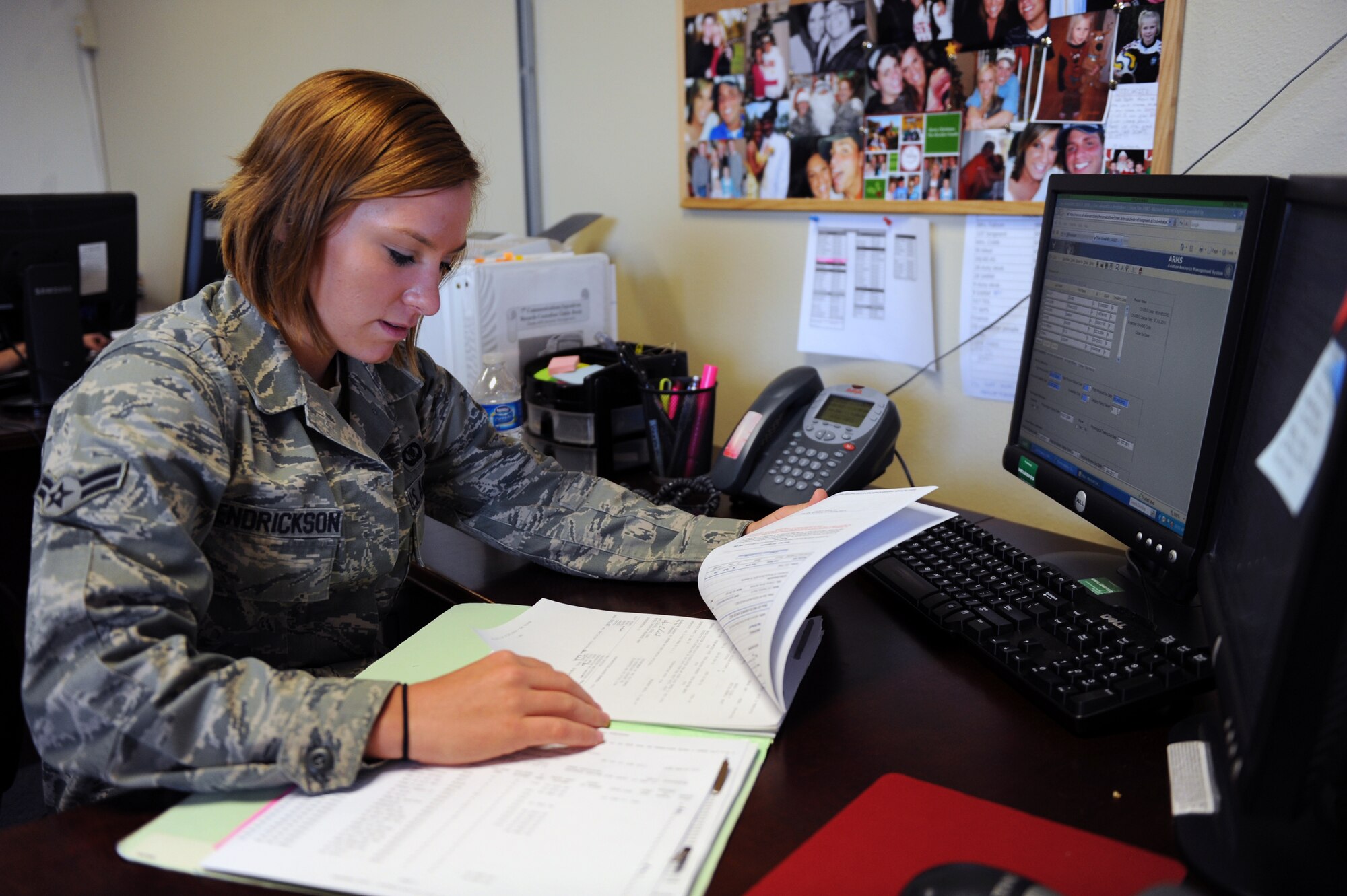DYESS AIR FORCE BASE, Texas--Airman 1st Class Alexandra Hendrickson, 7th Operations Support Squadron aviation resource manager, looks over paperwork at her desk here July 7, 2011. Airman Hendrickson became one of the few Airmen across the entire Air Force to ever attain a perfect score on their CDCs. (U.S. Air Force photo by Airman 1st Class Courtney Moses/Released)