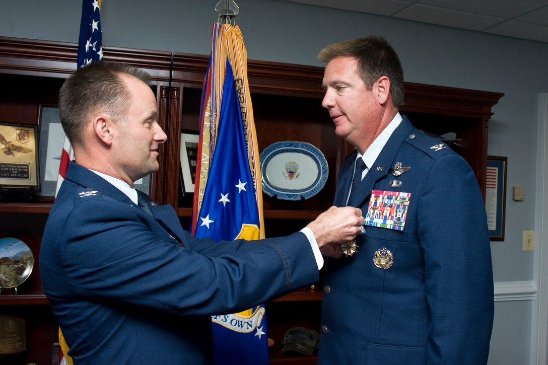 Colonel Ken Rizer, 11th Wing/Joint Base Andrews commander, awards the Legion of Merit, second oak leaf cluster, to Col. Lee K. dePalo, 11th Wing/Joint Base Andrews vice commander, during a ceremony held June 15. Colonel dePalo was awarded the distinction for exceptionally meritorious conduct in the performance of outstanding services during his tenure at Joint Base Andrews. (Photo by Bobby Jones)