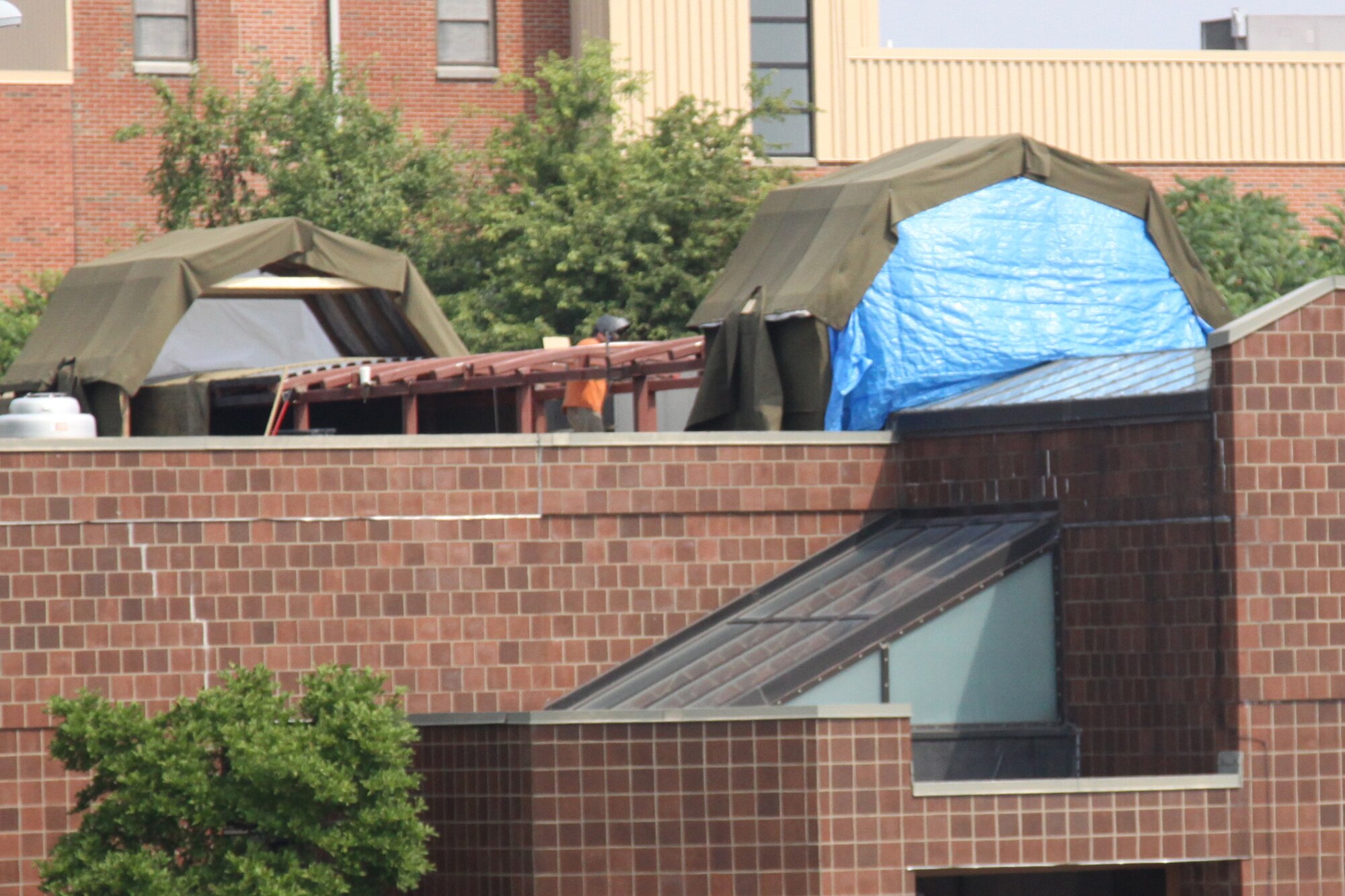 Contractors replace leaking skylights on the roof of the 911th Airlift Wing’s Avionics building, July 7.  Tents were erected as a precautionary measure in the event of poor weather during construction.  Estimated completion of the project is late August 2011. (U.S. Air Force photo/by Senior Airman Melissa S. Knox)