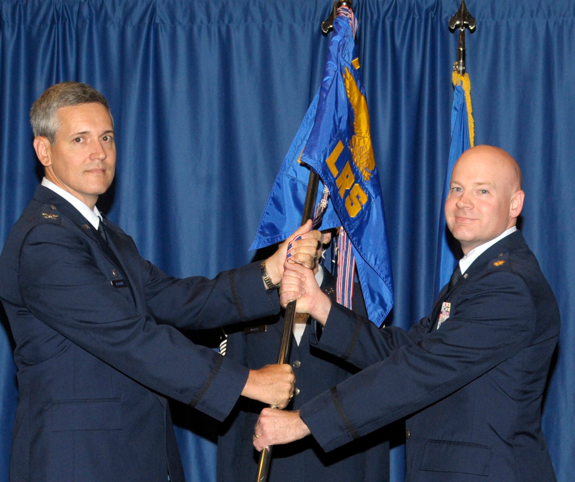 Maj. Jon Robinson, right, accepts the 71st Logistics Readiness Squadron guidon from Col. Michael McDaniel, 71st Mission Support Group commander, during a change of ceremony held July 7 at the Vance Collocated Club at Vance AFB, Okla. Relinquishing command of the unit was Lt. Col. Raymond Cirasa, who will be reassigned to Scott AFB, Ill. Robinson comes to Vance from the U.S. Strategic Command at Offutt AFB, Neb. (U.S. Air Force photo/ Roger Betz)
