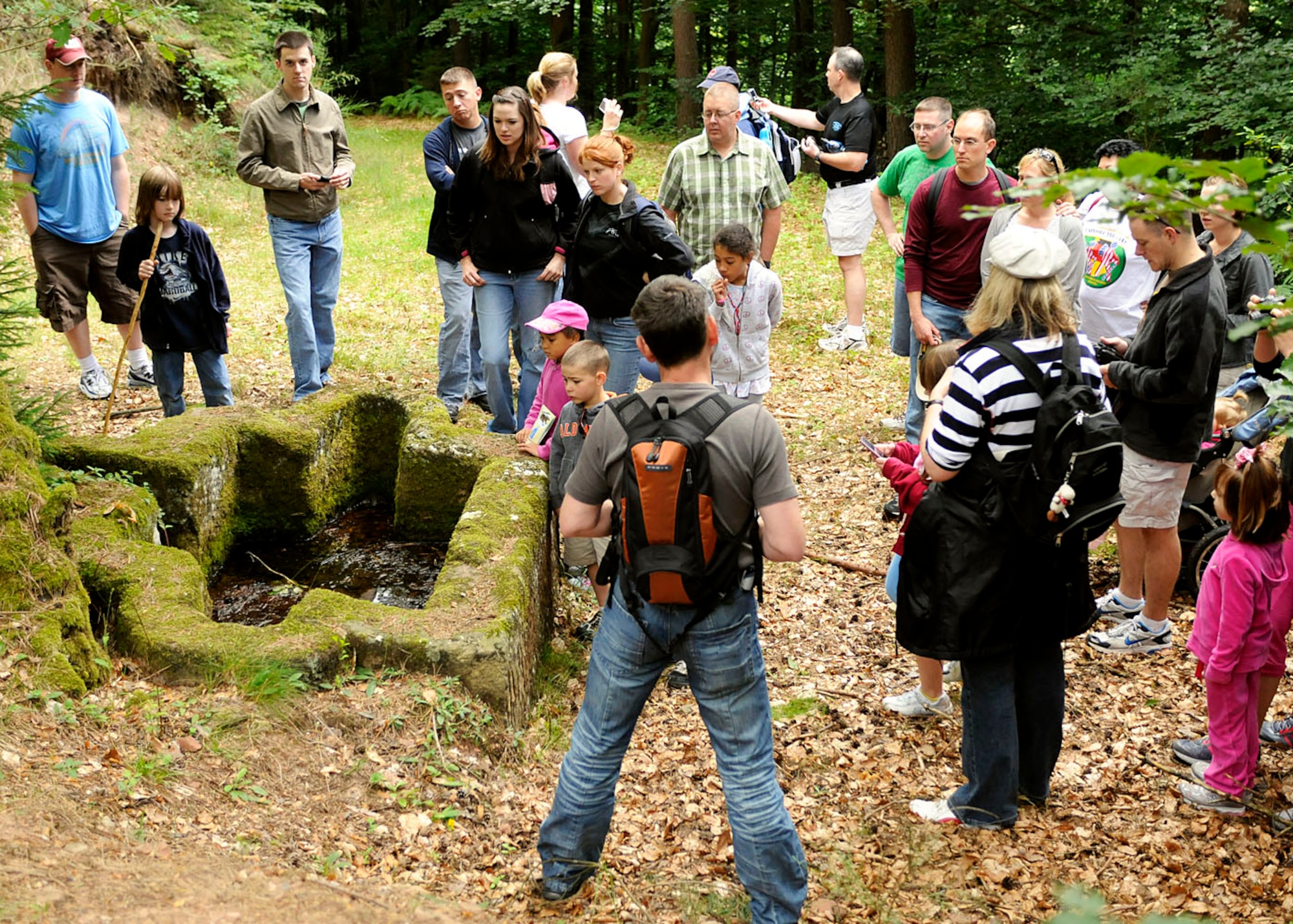 SPANGDAHLEM AIR BASE, Germany -- Base members inspect an ancient Roman grave site in the Meulenwald Forest outside Landscheid-Neiderkail during an Explore the Eifel event July 2. The 10-kilometer walk also included a visit to the remnants of a Celtic village wall and a poet’s 200-year-old house. Explore the Eifel is an annual base occurrence to give Sabers a chance to tour the local area. (U.S. Air Force photo / Senior Airman Daryl Knee)