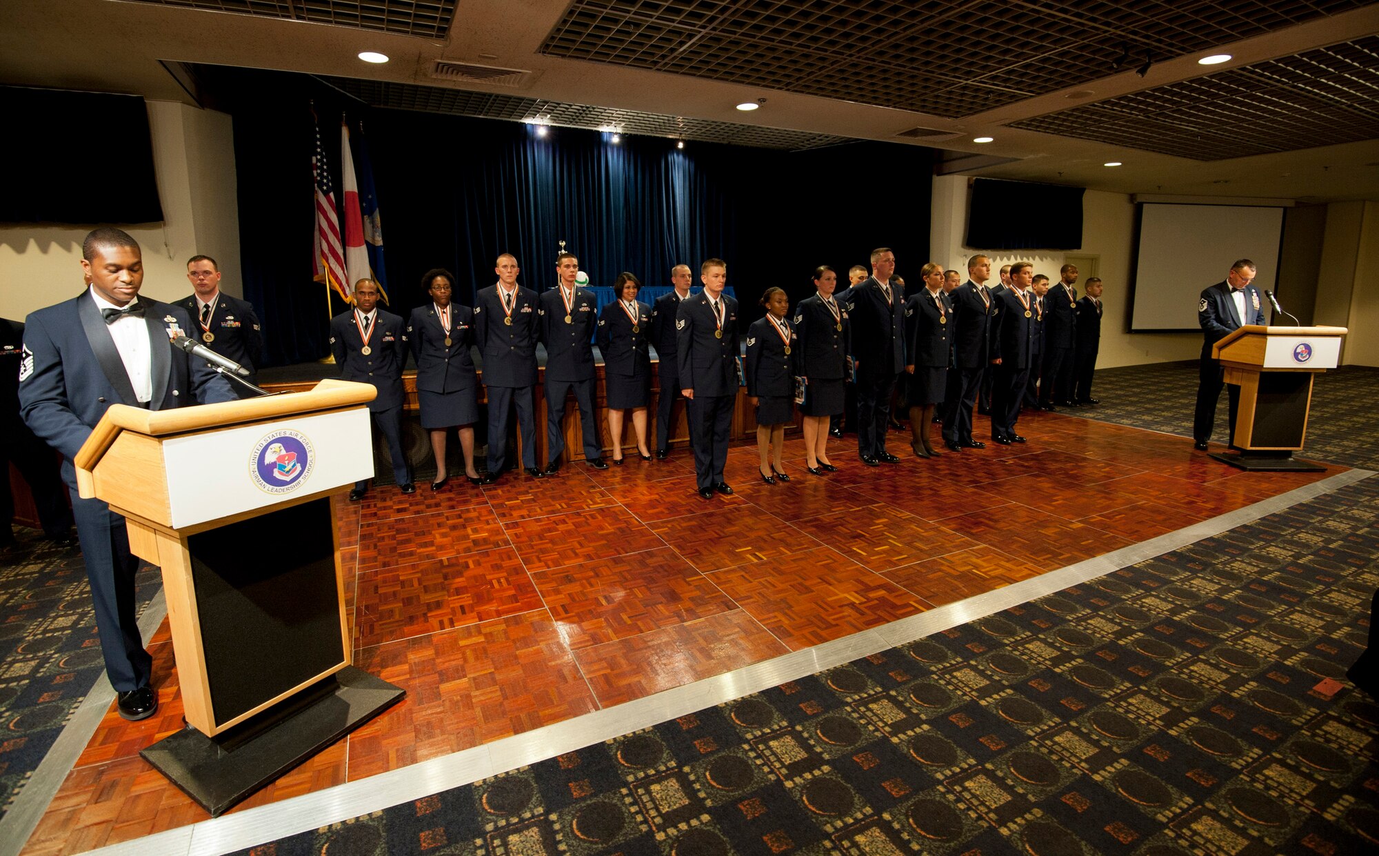 YOKOTA AIR BASE, Japan -- Seven staff sergeants are inducted into the NCO corps during the Airman Leadership School Class 11-E graduation at Yokota Air Base, Japan, July 7, 2011. ALS teaches senior airmen how to become leaders and mentors for the next generation of Airmen. (U.S. Air Force photo/Staff Sgt. Samuel Morse)