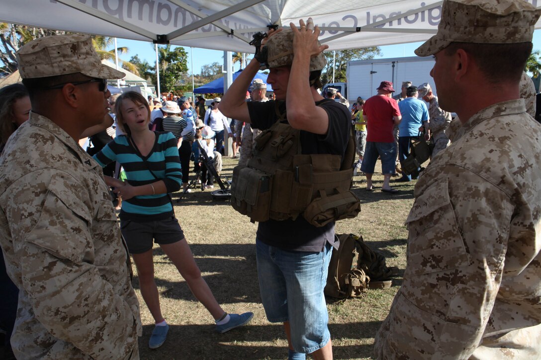 Peter Ross from Rockhampton, Australia, tries on a U.S. Marine issued flak jacket and helmet during the opening day of Exercise Talisman Sabre 2011, July 9.  TS11 demonstrates the United States and Australian commitment to their military alliance, and enhances stability and security throughout the Asia-Pacific region. The 31st MEU is the only continually forward-deployed MEU, and remains the nation's force-in-readiness in the Asia-Pacific region.