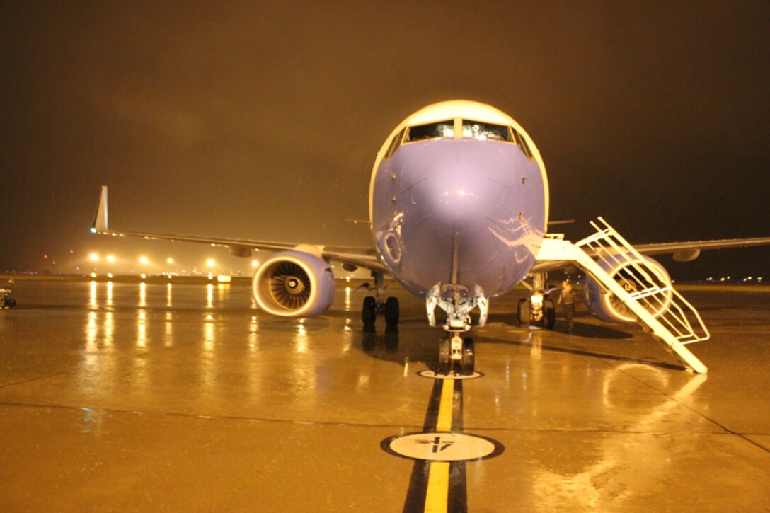 An evening training flight is prepped by the 932nd Airlift Wing Maintenance Group with a mixed crew of active duty and Air Force Reserve members, part of the Total Force Integration (TFI) at Scott Air Force Base. The wing maintains the C-40C aircraft seen in the background. (U.S. Air Force photo/Maj. Stan Paregien)