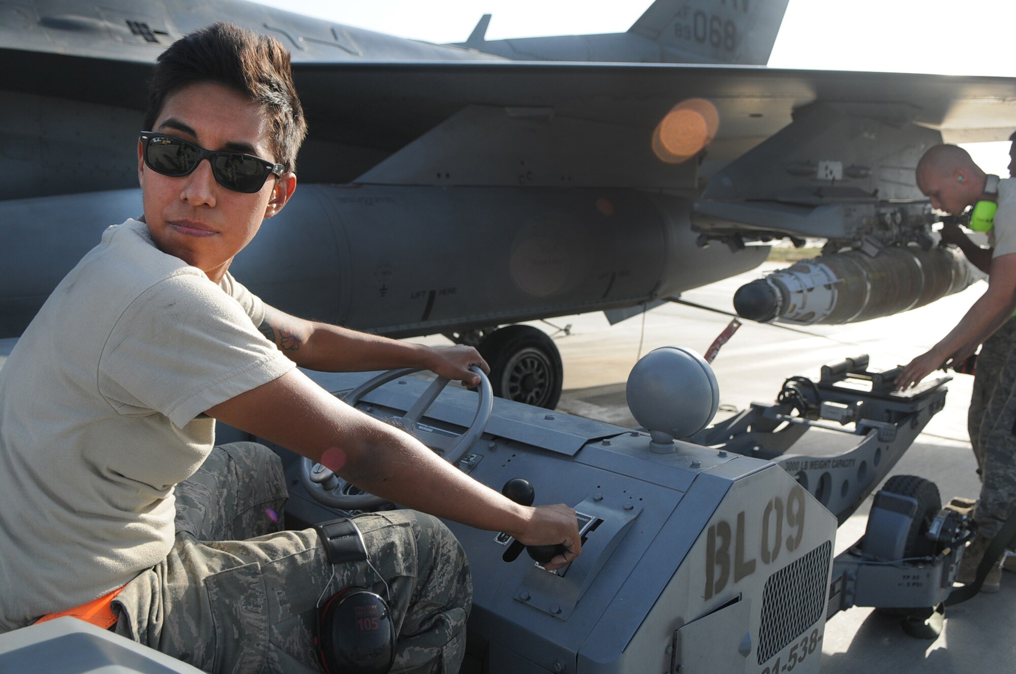 BAGRAM AIRFIELD, Afghanistan -- Senior Airman Rebecca Ortiz, 455th Expeditionary Aircraft Maintenance Squadron weapons load crew chief, loads a GBU-54 bomb onto an F-16 Fighting Falcon here July 7. Airman Ortiz is responsible for inspecting and loading munitions. The inspection process consists of examining munitions for defects, imperfections and ensuring they match mission requirements. After the bombs have been loaded they go through a minimum of five additional inspections before the F-16 takes off. Airman Ortiz is stationed at Aviano Air Base, Italy. (U.S. Air Force photo by Senior Airman Krista Rose) 