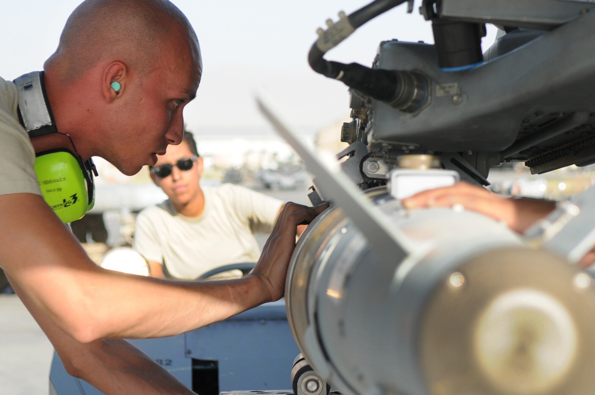 BAGRAM AIRFIELD, Afghanistan -- Staff Sgt. Juan Rodriguez Lopez, 455th Expeditionary Aircraft Maintenance Squadron weapons load crew chief, loads a GBU-54 bomb onto an F-16 Fighting Falcon here July 7. Sergeant Lopez is responsible for inspecting and loading munitions. The inspection process consists of examining munitions for defects, imperfections and ensuring they match mission requirements. After the bombs have been loaded they go through a minimum of five additional inspections before the F-16 takes off. Sergeant Rodriguez Lopez is stationed at Aviano Air Base, Italy. (U.S. Air Force photo by Senior Airman Krista Rose) 