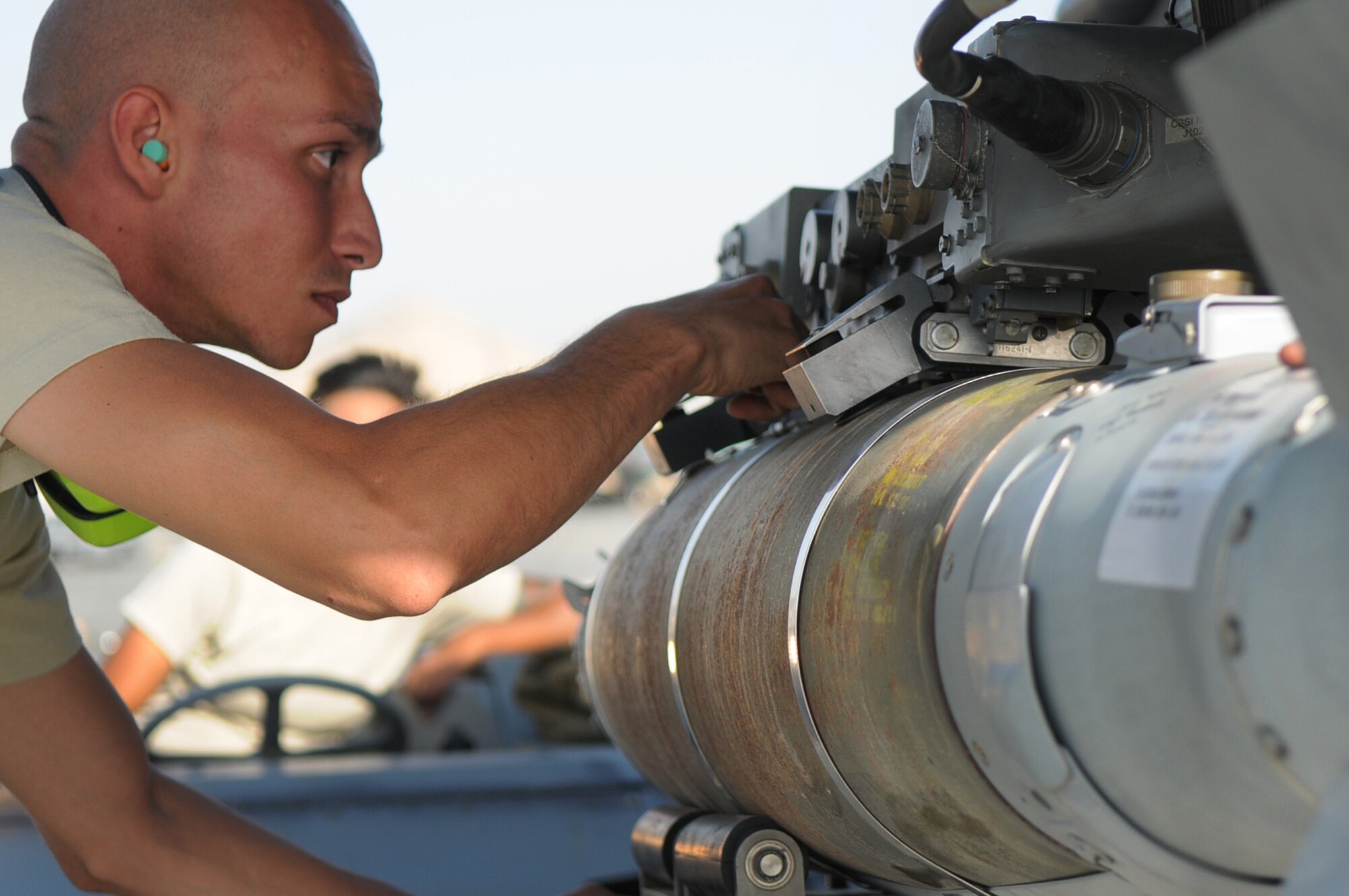 BAGRAM AIRFIELD, Afghanistan -- Staff Sgt. Juan Rodriguez Lopez, 455th Expeditionary Aircraft Maintenance Squadron weapons load crew chief, loads a GBU-54 bomb onto an F-16 Fighting Falcon here July 7. Sergeant Lopez is responsible for inspecting and loading munitions. The inspection process consists of examining munitions for defects, imperfections and ensuring they match mission requirements. After the bombs have been loaded they go through a minimum of five additional inspections before the F-16 takes off. Sergeant Rodriguez Lopez is stationed at Aviano Air Base, Italy. (U.S. Air Force photo by Senior Airman Krista Rose) 