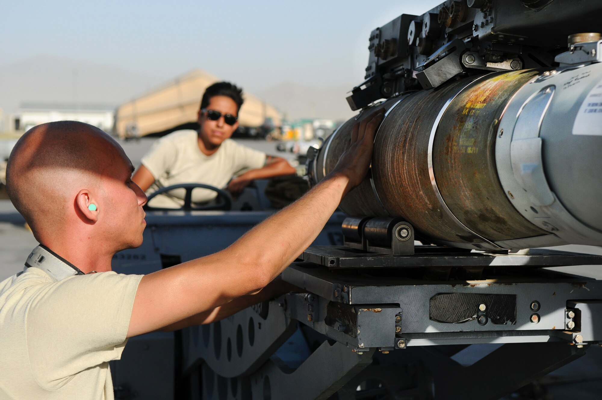 BAGRAM AIRFIELD, Afghanistan -- Staff Sgt. Juan Rodriguez Lopez, 455th Expeditionary Aircraft Maintenance Squadron weapons load crew chief, loads a GBU-54 bomb onto an F-16 Fighting Falcon here July 7. Sergeant Lopez is responsible for inspecting and loading munitions. The inspection process consists of examining munitions for defects, imperfections and ensuring they match mission requirements. After the bombs have been loaded they go through a minimum of five additional inspections before the F-16 takes off. Sergeant Rodriguez Lopez is stationed at Aviano Air Base, Italy. (U.S. Air Force photo by Senior Airman Krista Rose) 