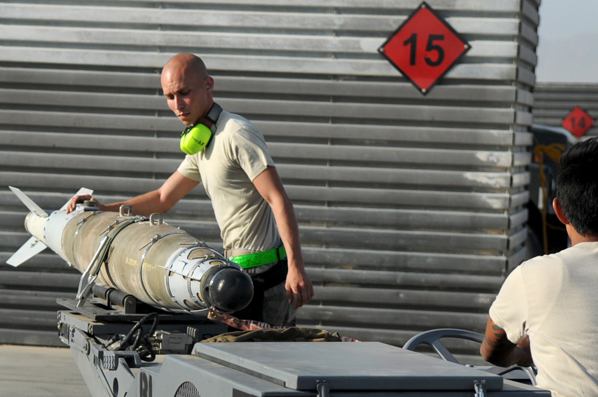 BAGRAM AIRFIELD, Afghanistan -- Staff Sgt. Juan Rodriguez Lopez, 455th Expeditionary Aircraft Maintenance Squadron weapons load crew chief, loads a GBU-54 bomb onto an F-16 Fighting Falcon here July 7. Sergeant Lopez is responsible for inspecting and loading munitions. The inspection process consists of examining munitions for defects, imperfections and ensuring they match mission requirements. After the bombs have been loaded they go through a minimum of five additional inspections before the F-16 takes off. Sergeant Rodriguez Lopez is stationed at Aviano Air Base, Italy. (U.S. Air Force photo by Senior Airman Krista Rose) 