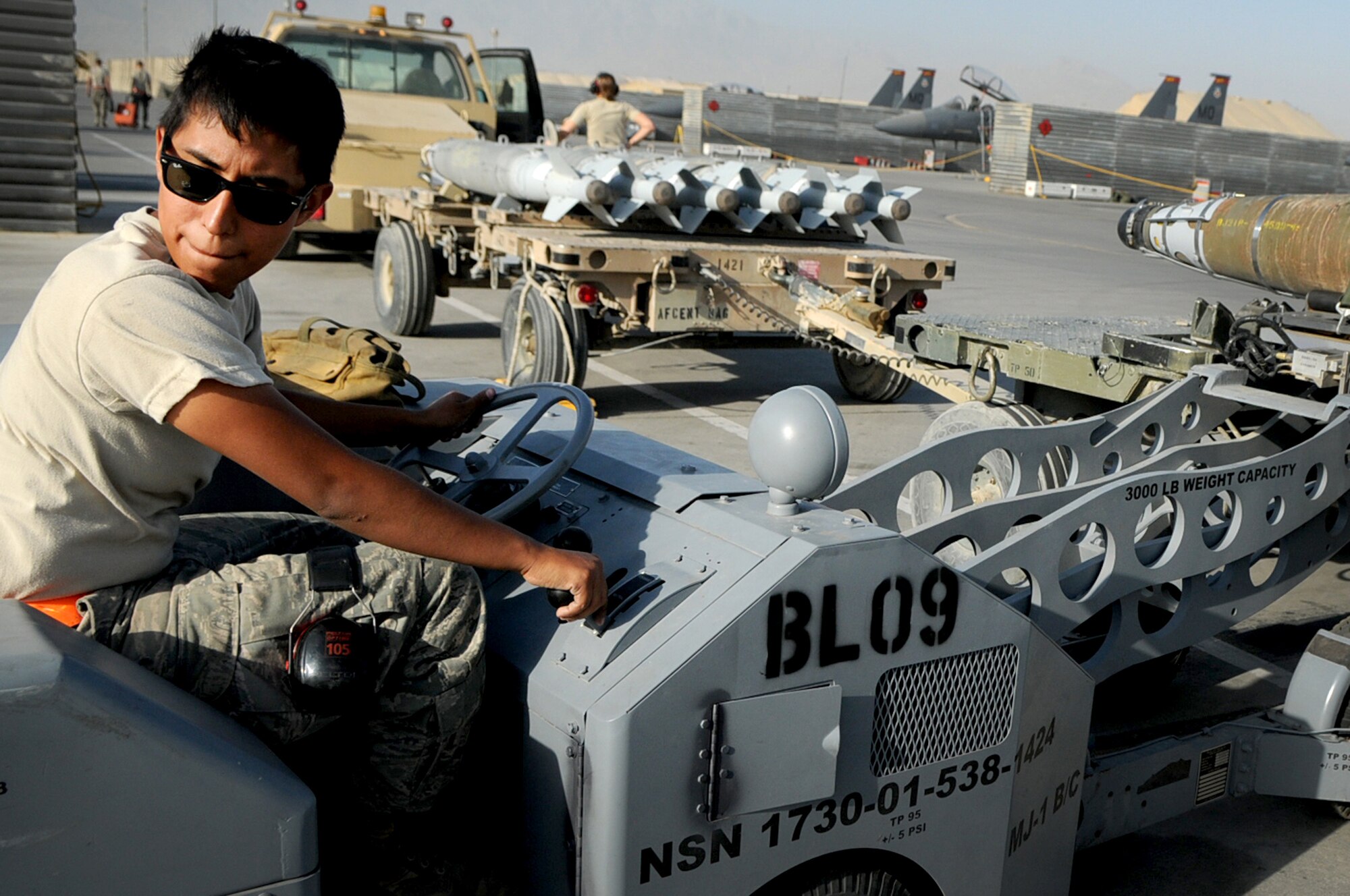 BAGRAM AIRFIELD, Afghanistan -- Senior Airman Rebecca Ortiz, 455th Expeditionary Aircraft Maintenance Squadron weapons load crew chief, loads a GBU-54 bomb onto an F-16 Fighting Falcon here July 7. Airman Ortiz is responsible for inspecting and loading munitions. The inspection process consists of examining munitions for defects, imperfections and ensuring they match mission requirements. After the bombs have been loaded they go through a minimum of five additional inspections before the F-16 takes off. Airman Ortiz is stationed at Aviano Air Base, Italy. (U.S. Air Force photo by Senior Airman Krista Rose) 