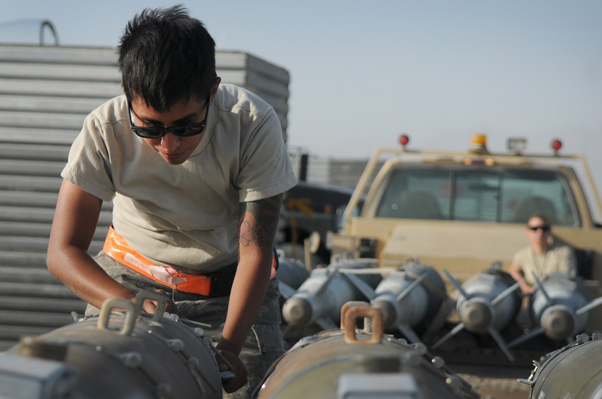BAGRAM AIRFIELD, Afghanistan -- Senior Airman Rebecca Ortiz, 455th Expeditionary Aircraft Maintenance Squadron weapons load crew chief, inspects GBU-54 bombs before loading them onto an F-16 Fighting Falcon here July 7. The inspection process consists of examining munitions for defects, imperfections and ensuring they match mission requirements. Airman Ortiz is stationed at Aviano Air Base, Italy. (U.S. Air Force photo by Senior Airman Krista Rose)