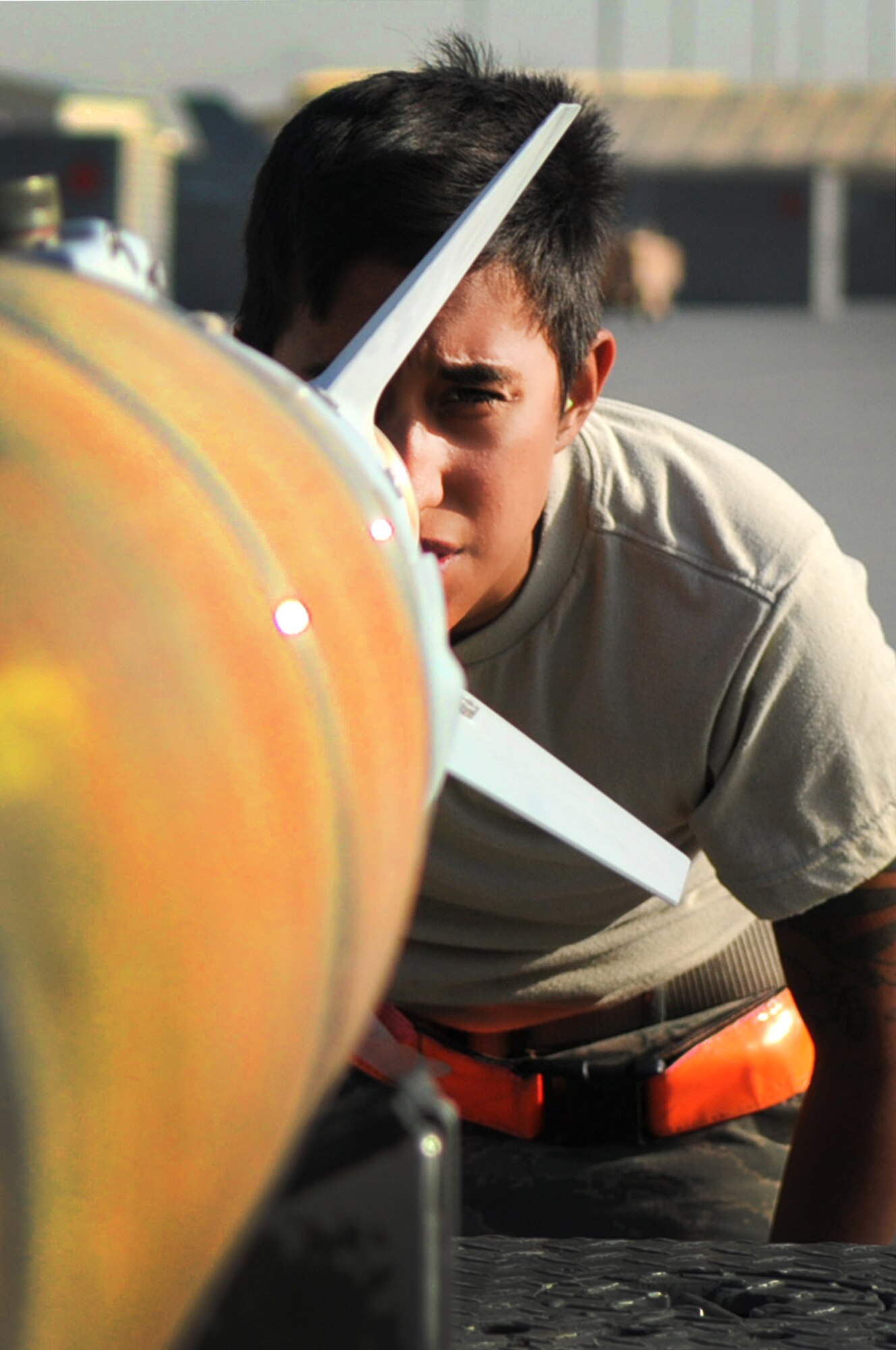 BAGRAM AIRFIELD, Afghanistan -- Senior Airman Rebecca Ortiz, 455th Expeditionary Aircraft Maintenance Squadron weapons load crew chief, inspects GBU-54 bombs before loading them onto an F-16 Fighting Falcon here July 7. The inspection process consists of examining munitions for defects, imperfections and ensuring they match mission requirements. Airman Ortiz is stationed at Aviano Air Base, Italy. (U.S. Air Force photo by Senior Airman Krista Rose)