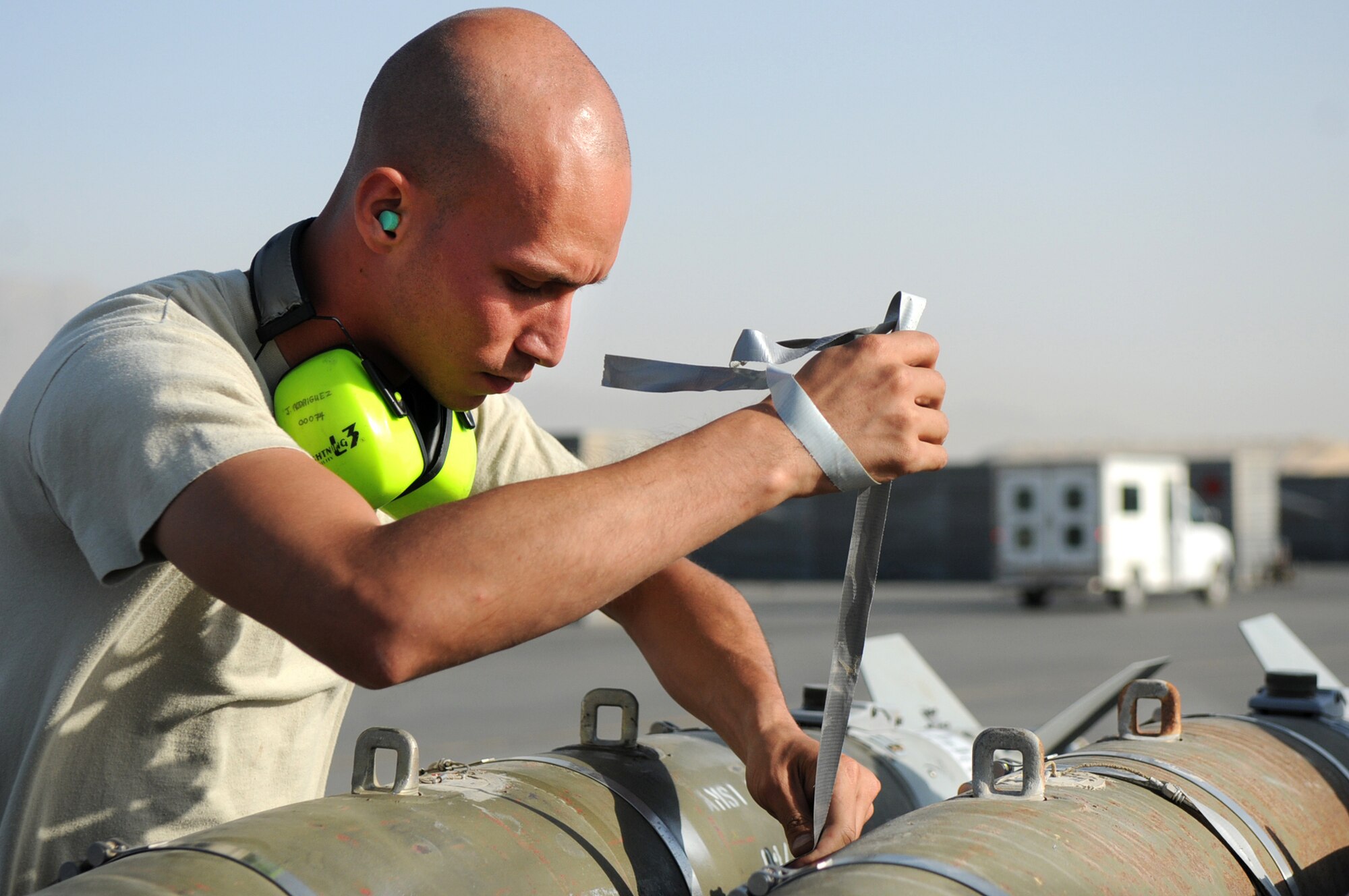 BAGRAM AIRFIELD, Afghanistan -- Staff Sgt. Juan Rodriguez Lopez, 455th Expeditionary Aircraft Maintenance Squadron weapons load crew chief, inspects GBU-54 bombs before loading them onto an F-16 Fighting Falcon here July 7. The inspection process consists of examining munitions for defects, imperfections and ensuring they match mission requirements. Sergeant Rodriguez Lopez is stationed at Aviano Air Base, Italy. (U.S. Air Force photo by Senior Airman Krista Rose) 