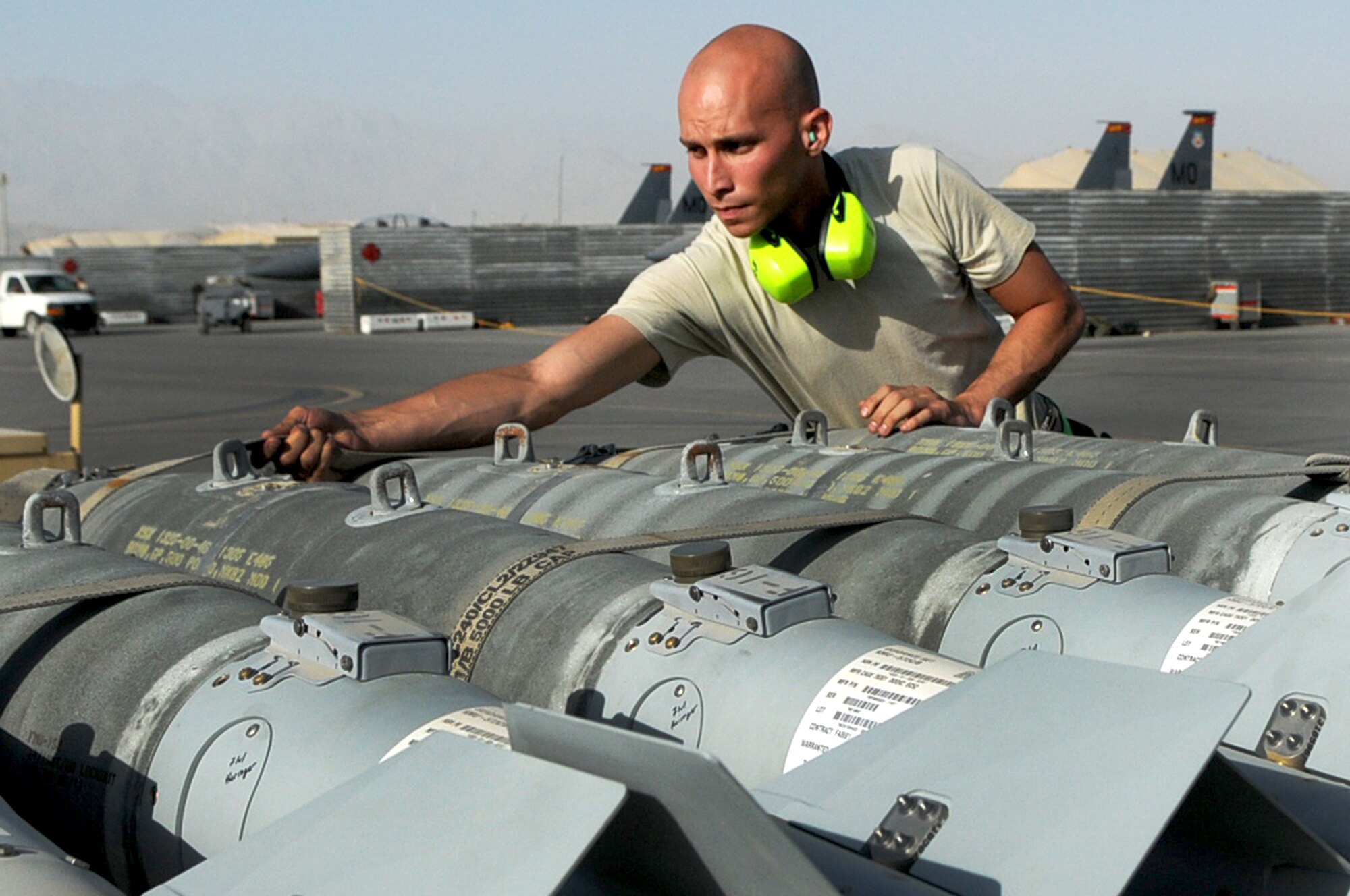 BAGRAM AIRFIELD, Afghanistan -- Staff Sgt. Juan Rodriguez Lopez, 455th Expeditionary Aircraft Maintenance Squadron weapons load crew chief, inspects GBU-38 bombs before loading them onto an F-16 Fighting Falcon here July 7. The inspection process consists of examining munitions for defects, imperfections and ensuring they match mission requirements. Sergeant Rodriguez Lopez is stationed at Aviano Air Base, Italy. (U.S. Air Force photo by Senior Airman Krista Rose) 