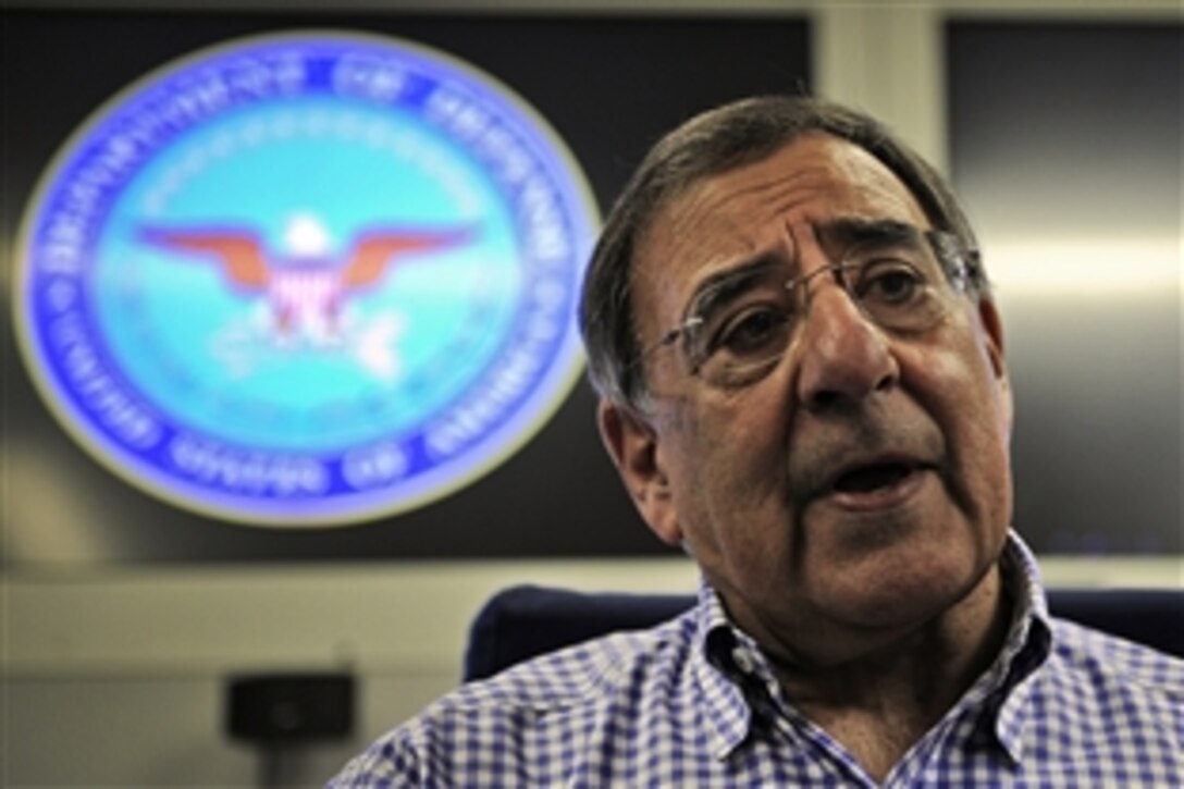 U.S. Defense Secretary Leon E. Panetta, who was sworn in to office July 1, 2011, speaks to traveling press pool members aboard a U.S. Air Force E-4B aircraft, July 8. 