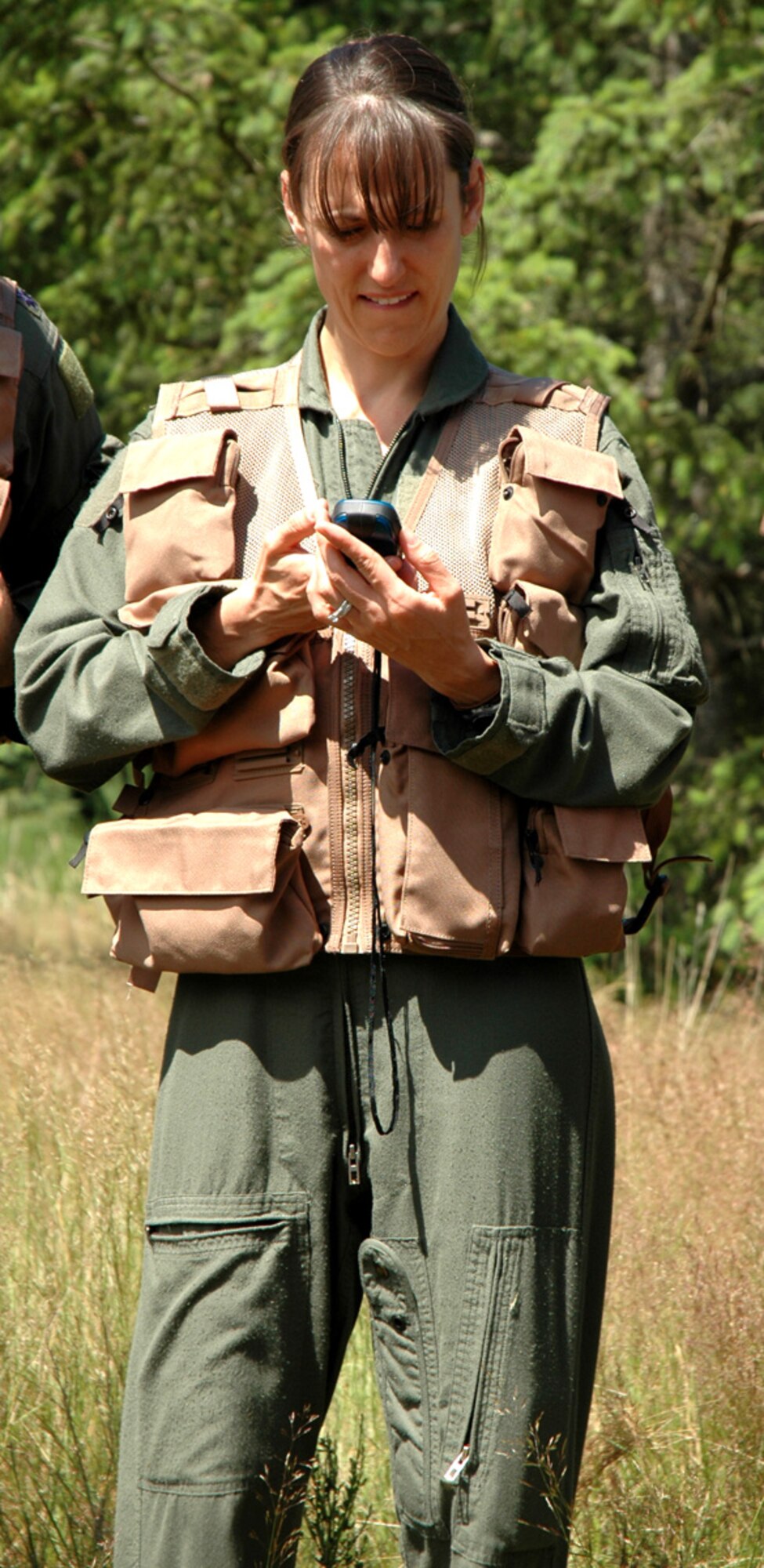 U.S. Air Force Capt. Dana Dailey, a C-17 Globemaster III pilot with the 728th Airlift Squadron, dials in coordinates on a portable GPS device during a Survival Evasion Resistance Escape training exercise July 9 at McChord Field, Wash.  Aircrew members with the 446th Airlift Wing are required to complete SERE training every three years. (U.S. Air Force photo by Staff Sgt. Grant Saylor) 