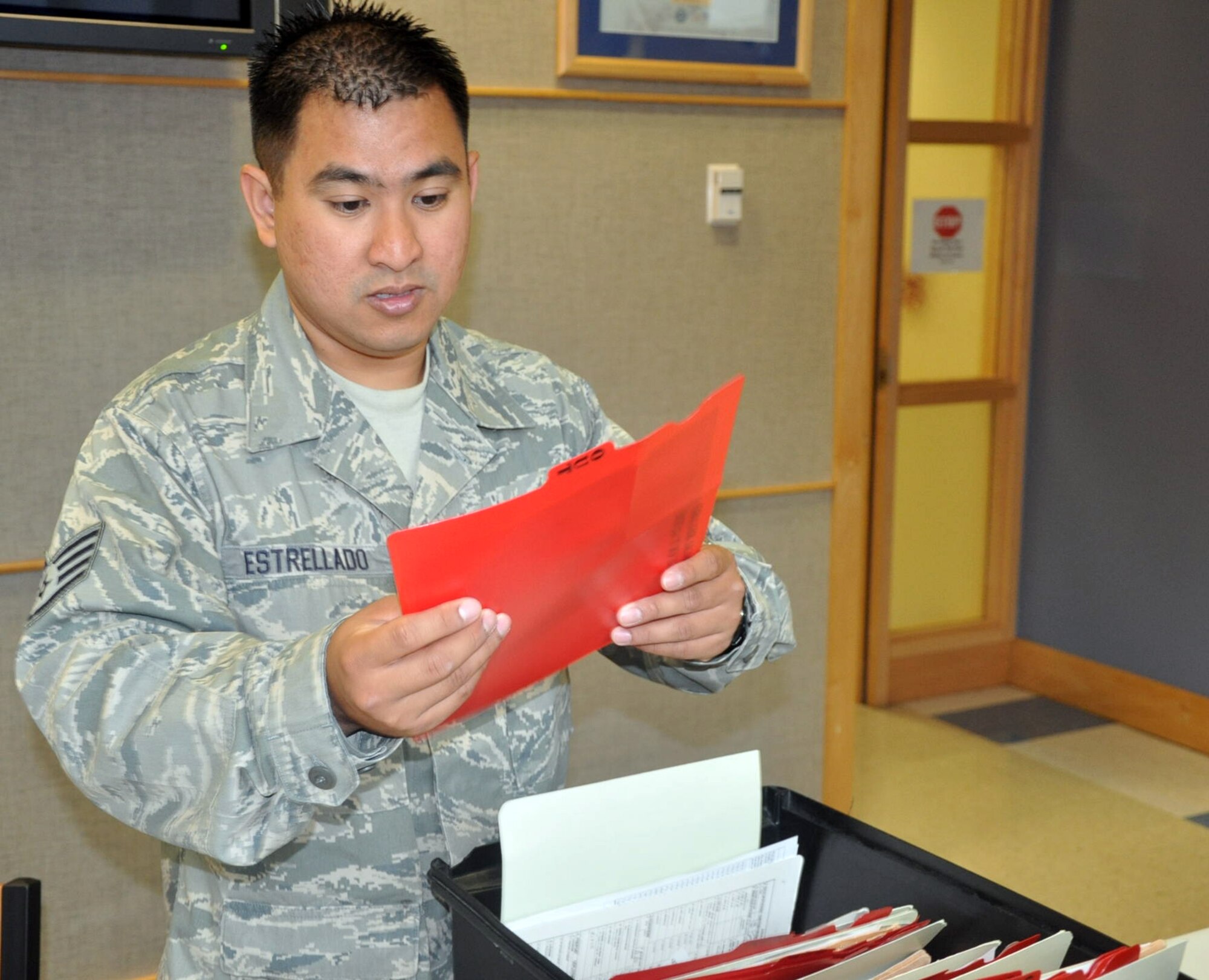 MCCHORD FIELD, Wash. - Staff Sgt. Peter Estrellado, 446th Aerospace Medicine Squadron health services manager here, reviews records in the Airmen's clinic July 10.  The nine-year Reservist is a Seattle native and an equipment service worker for King County Metro in his civilian job. (U. S. Air Force photo by Tech. Sgt. Elizabeth Moody)