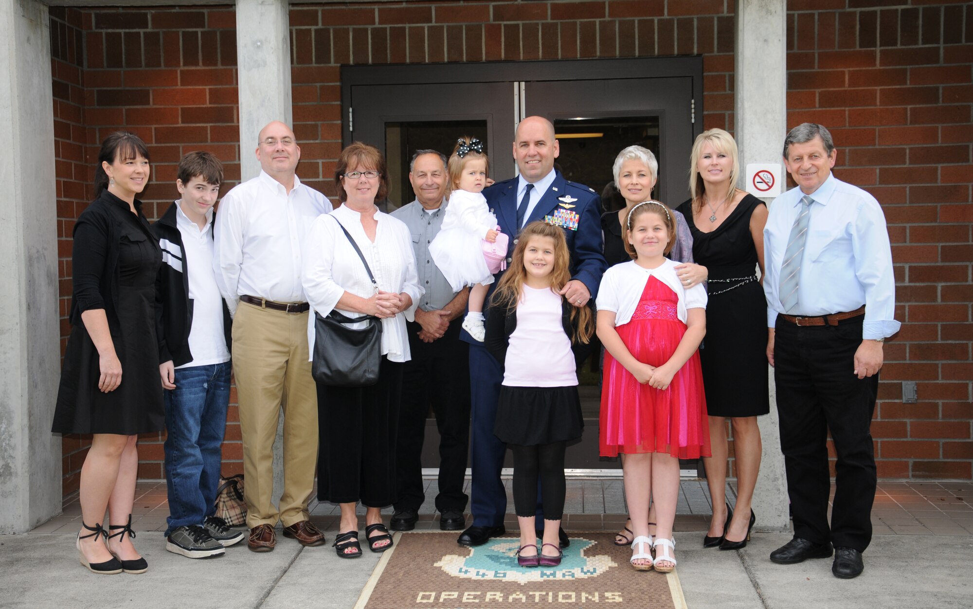 Lt. Col. James Dignan, pictured with his large family, assumed command of the 446th Operations Group in a ceremony July 10 at McChord Field.  An Assumption of Command ceremony is performed when the former commander has taken a new assignment before the new commander arrives on station.  Lt. Col. Dignan comes to the 446th AW from Jerusalem where he was the deputy chief of plans for the U.S. security coordinator for Israel and Palestine. (U.S. Air Force photo by 2nd Lt. Denise Hauser)