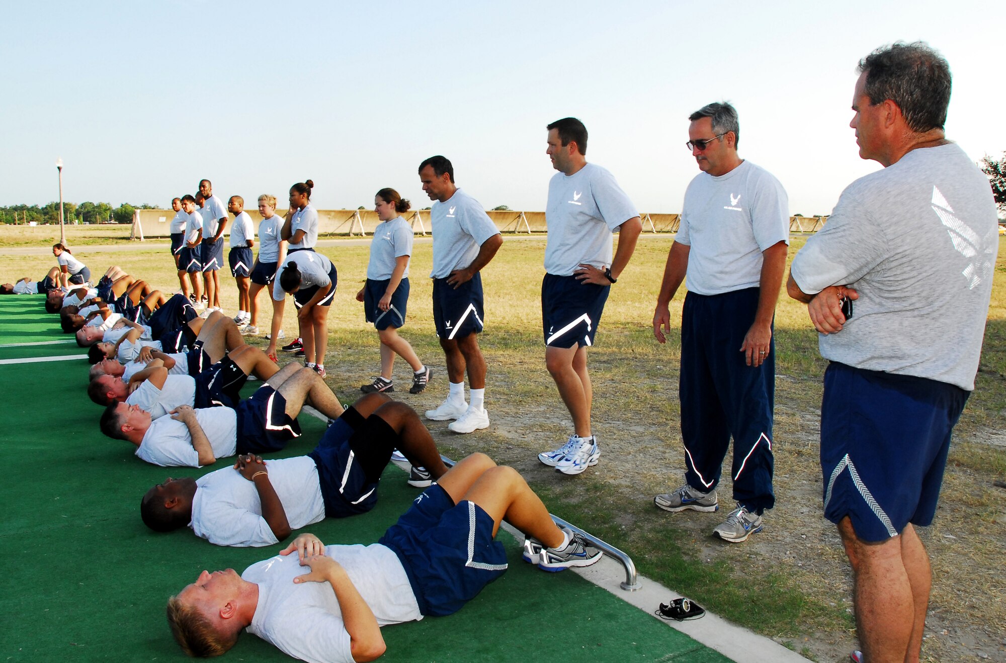 Reservists from the 403rd Wing prepare for sit-ups as the Health and Wellness Center team explains the proper technique and rules of the physical fitness test. It has been a little over a year since the Air Force changed the standards of fitness. (U.S. Air Force Photo/ Staff Sgt. Tabitha Dupas)