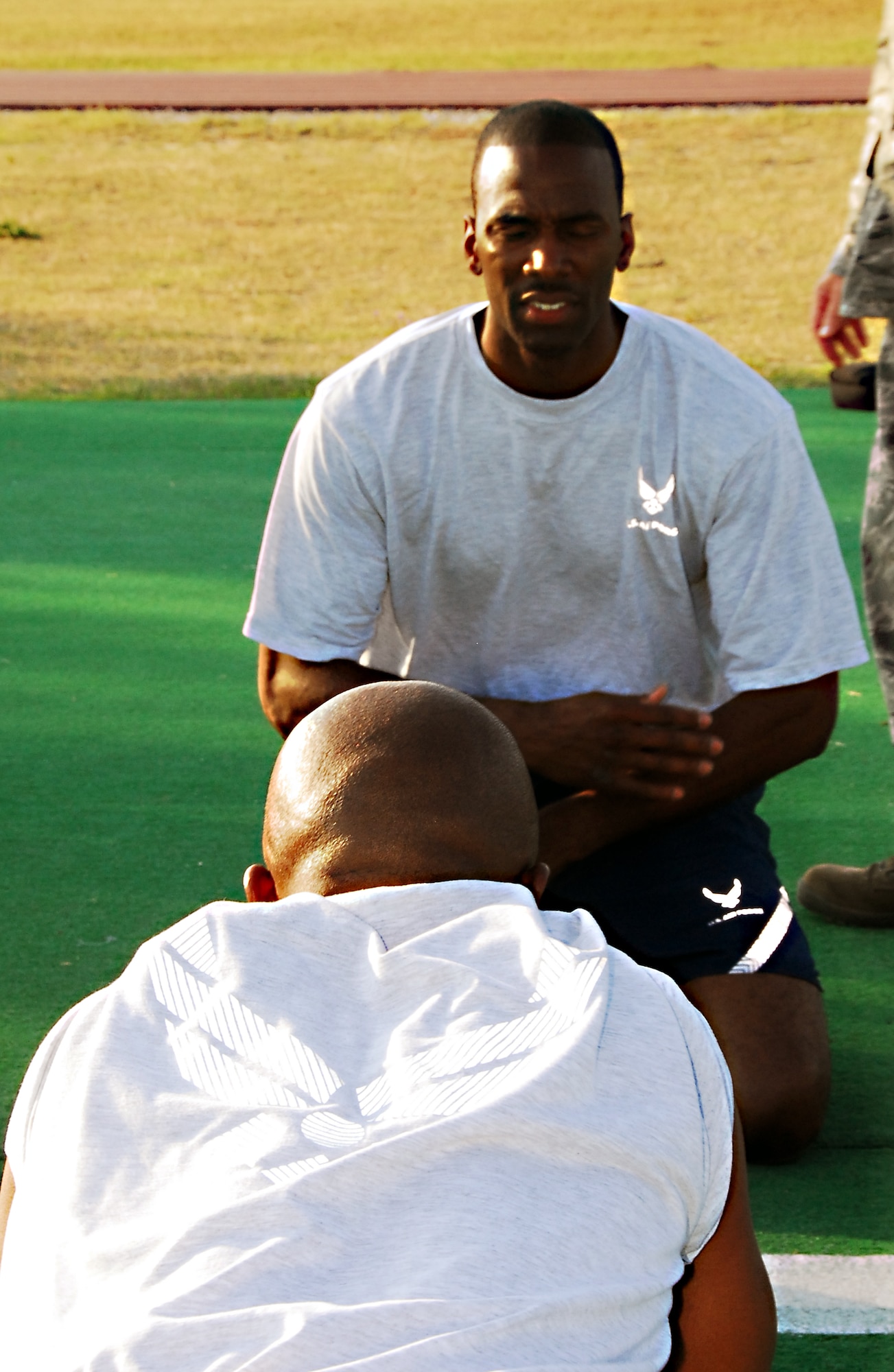 Master Sgt. Ronald Martin, 403rd Avionics, counts for Senior Airmen Chis King, 403rd Avionics, as he does his push-ups during the physical fitness test during July's UTA. The new Air Force fitness standards have been effective for a little over a year. (U.S. Air Force Photo by Staff Sgt. Tabitha Dupas)