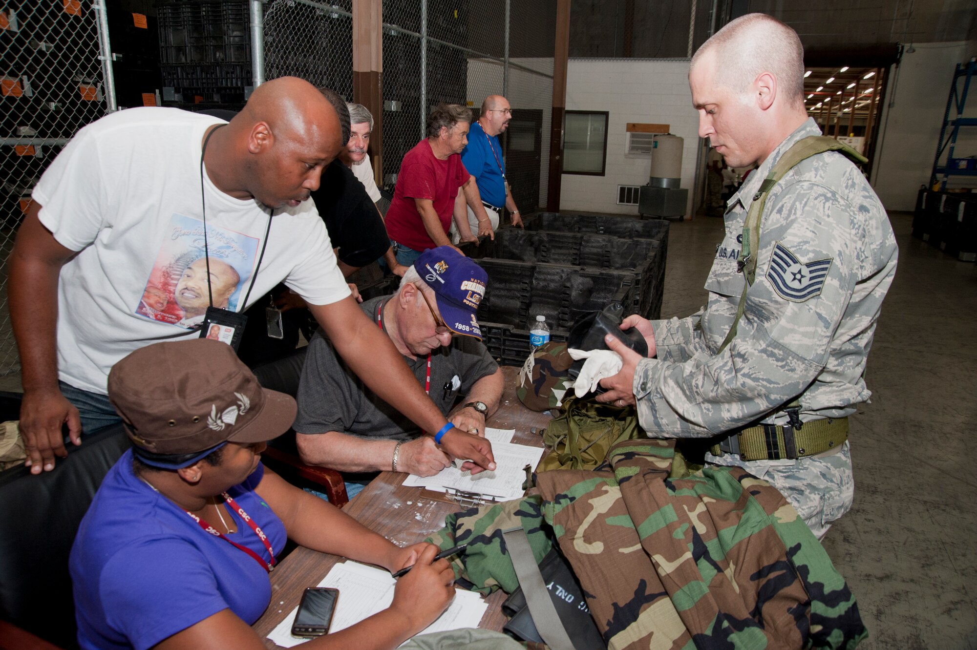 Tech. Sgt. Joel Wilson, 41st Aerial Port Squadron air transportation craftsman, processes through the simulated passenger terminal during the pre-deployment portion of the Readiness Assistance Visit 2 held during the July unit training assembly. Members of the 81st Computer Science Corporation, a civilian contractor with the 81st Training Wing, took inventory of the training gear issued to 403rd Wing members and ensured their mobility folders had accurate documentation. (U.S. Air Force photo/Tech. Sgt. Ryan Labadens)