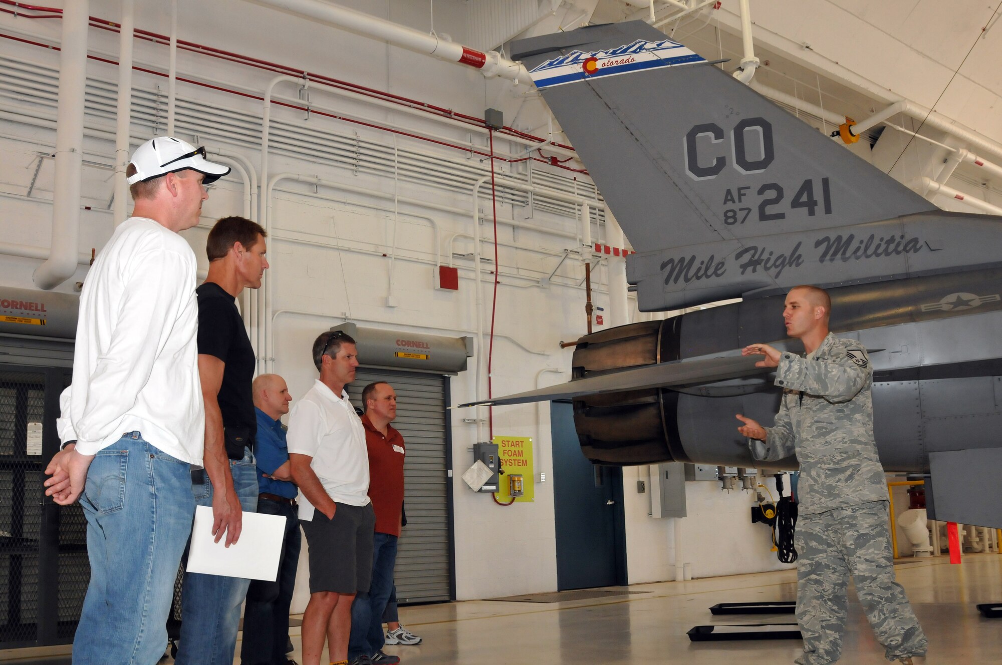 Master Sgt. John McCallick, 140th Maintenance Squadron, talks with Civilian employers of Colorado Air National Guard members about the F-16 Fighting Falcon, July 9, 2011.  The employers are taking part in the Employer Support of the Guard and Reserve day with the 140th Wing located at Buckley Air Force Base.  Air National Guard members nominated their employers to take part in the ESGR day events, providing the employer an opportunity to experience what their support allows the guard to do as well as a chance for the wing to show their appreciation to them.   (U.S. Air Force photo by: Tech. Sgt. Wolfram M. Stumpf)(RELEASED)