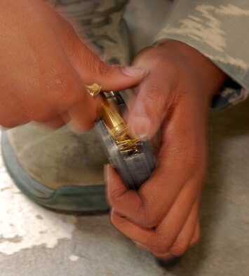 Airman 1st Class Jessica Nowell, 94th Security Forces Squadron, rapidly loads 5.56mm ammunition into an M-4 carbine magazine prior to live fire training at Dobbins Air Reserve Base during the monthly Unit Training Assembly, July 9.  94th Security Forces Combat Arms Training and Maintenance instructors conduct the training with several hours of classroom and firing range instruction ending with a qualification course of fire.  (U.S. Air Force photo/ Brad Fallin)