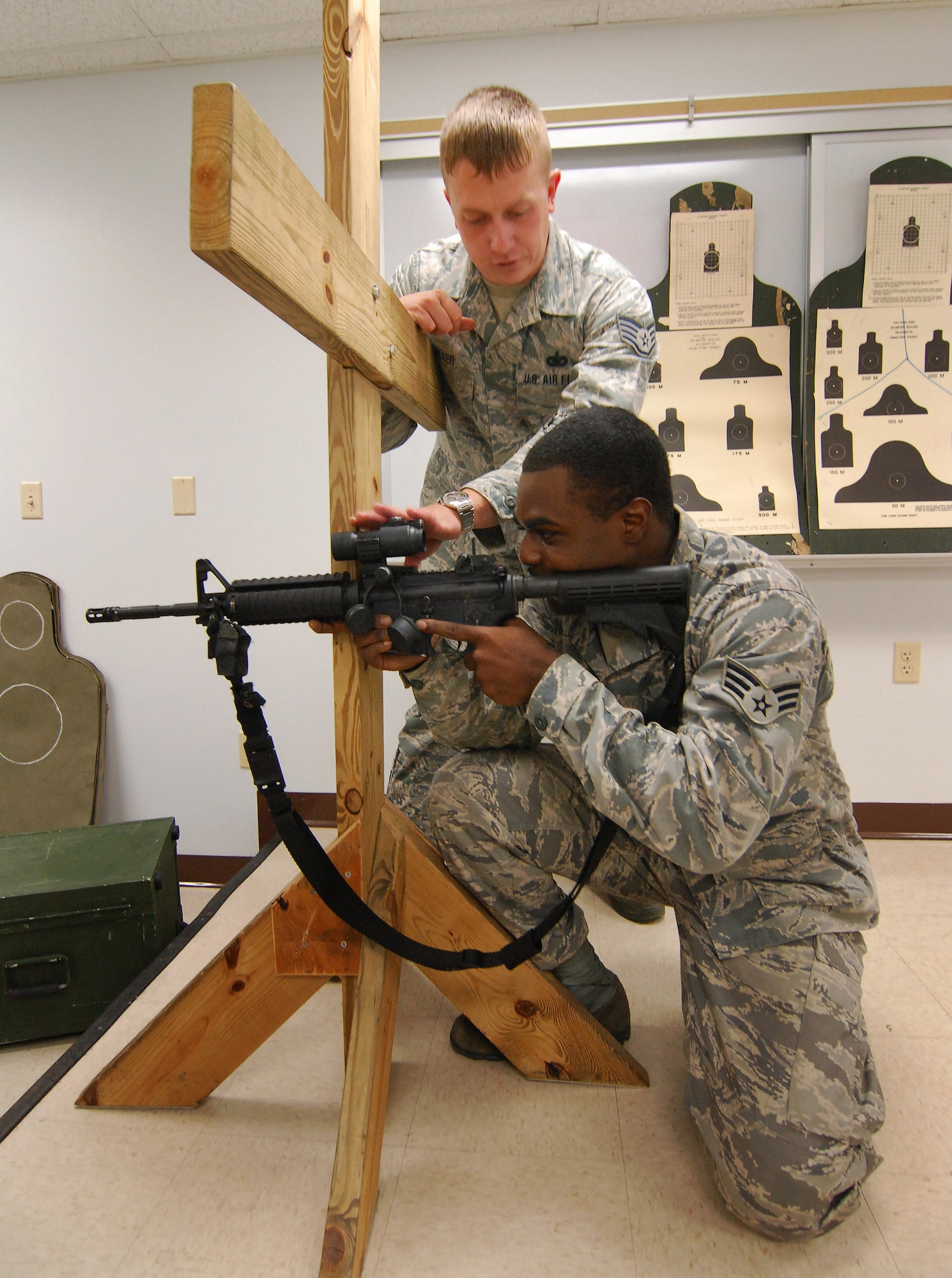 Staff Sgt. Sean Walker instructs Senior Airman Derrick Clark, both from the 94th Security Forces Squadron, on the best use of a barricade to ensure the most accurate shooting with the M-4 carbine at Dobbins Air Reserve Base during the monthly Unit Training Assembly, July 9.  94th Security Forces Combat Arms Training and Maintenance instructors conduct the training with several hours of classroom and firing range instruction ending with a qualification course of fire.  (U.S. Air Force photo/ Brad Fallin)