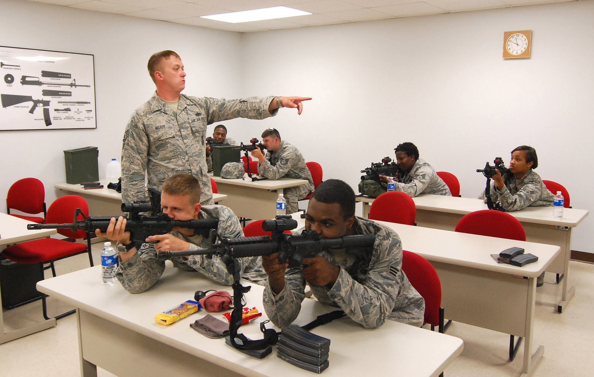 Staff Sgt. Sean Walker, 94th Security Forces Squadron, provides classroom instruction on the M-4 carbine for Security Forces Airmen at Dobbins Air Reserve Base during the monthly Unit Training Assembly, July 9.  94th Security Forces Combat Arms Training and Maintenance instructors conduct the training with several hours of classroom and firing range instruction ending with a qualification course of fire.  (U.S. Air Force photo/ Brad Fallin)