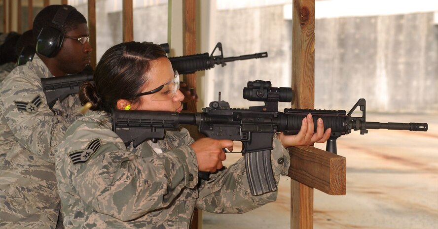 Staff Sgt.  Barbara Denisi, 94th Security Forces Squadron, fires the M-4 carbine for qualification at Dobbins Air Reserve Base during the monthly Unit Training Assembly, July 9.  94th Security Forces Combat Arms Training and Maintenance instructors conduct the training with several hours of classroom and firing range instruction ending with a qualification course of fire.  (U.S. Air Force photo/ Brad Fallin)