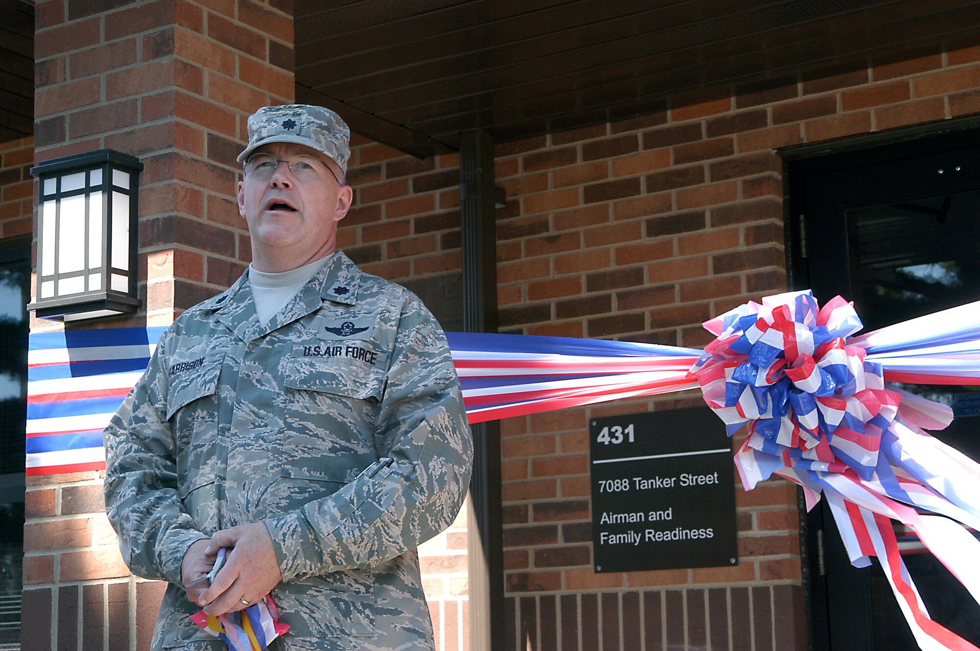 GRISSOM AIR RESERVE BASE, Ind.-- Lt. Col. Daniel Harrison, 434th Force Support Squadron commander, speaks in front of the new location for the Grissom Airman and Family Readiness Center before a ribbon cutting ceremony here July 9. The new building provides more space for Airmen and their family members. It also houses the 434th Seasoning Training Flight, the sexual assault response coordinator, newcomers flight, the 434th ARW chaplain?s office and maintenance supply liaison office. (U.S. Air Force photo/Senior Airman Damon Kasberg)           